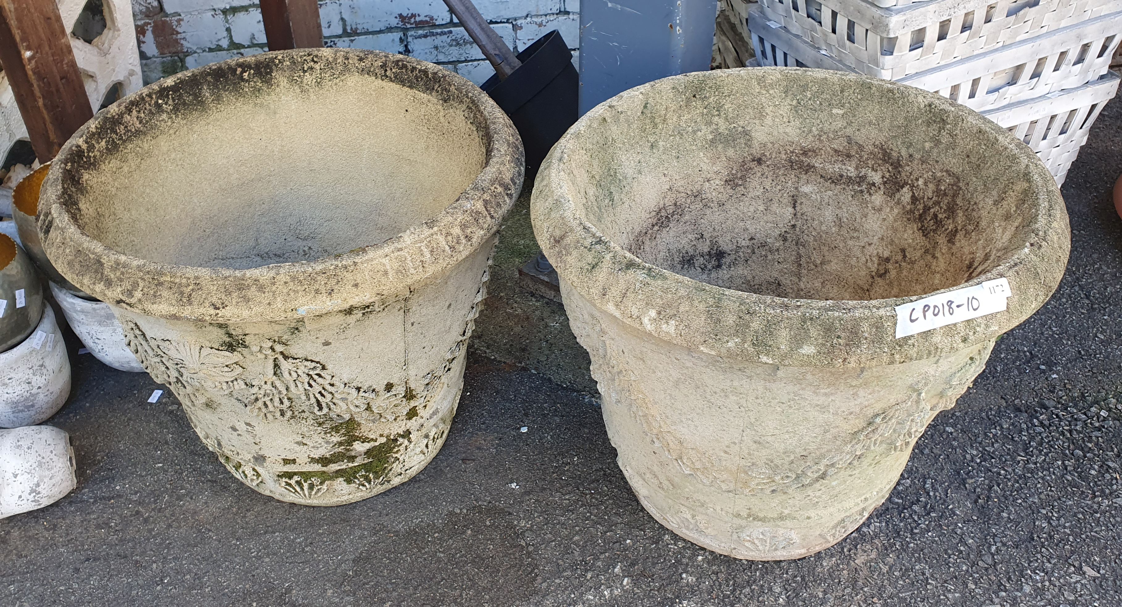 1172 · A PAIR OF DECORATIVE CONCRETE POTS