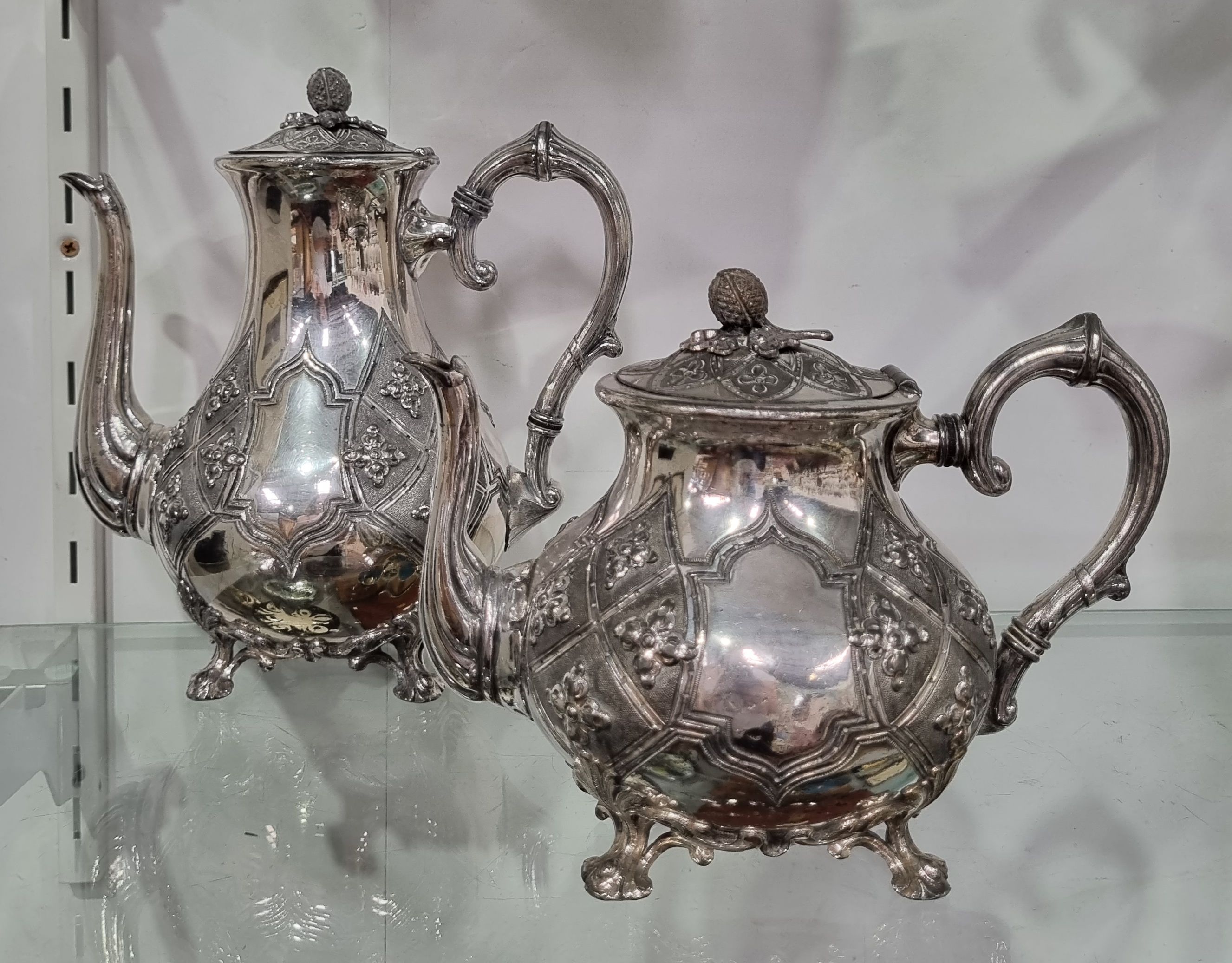 A LATE VICTORIAN BRITANNIA METAL TEAPOT AND HOT WATER POT