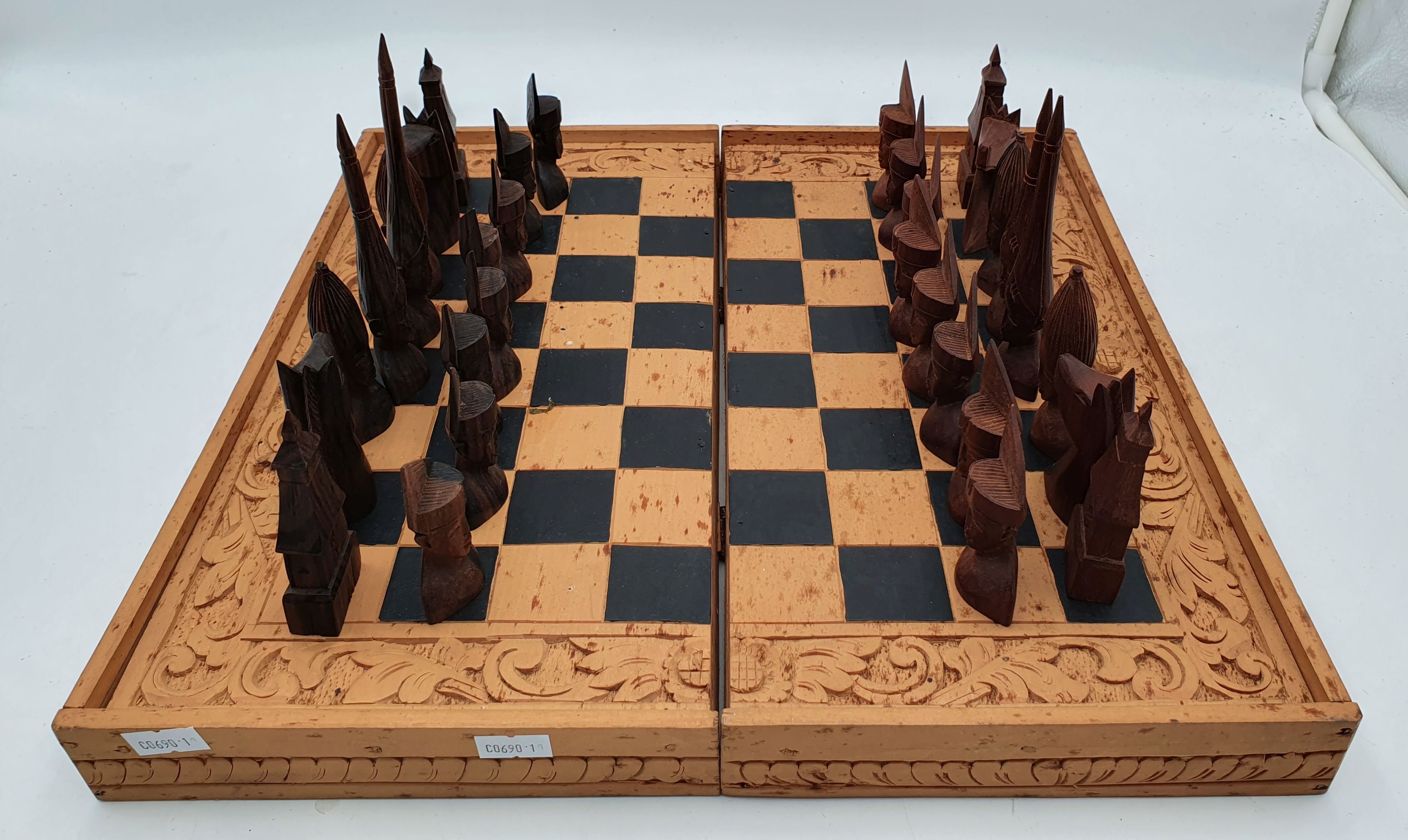 621 · A BALINESE WOODEN CHESS SET WITH FOLDING BOARD