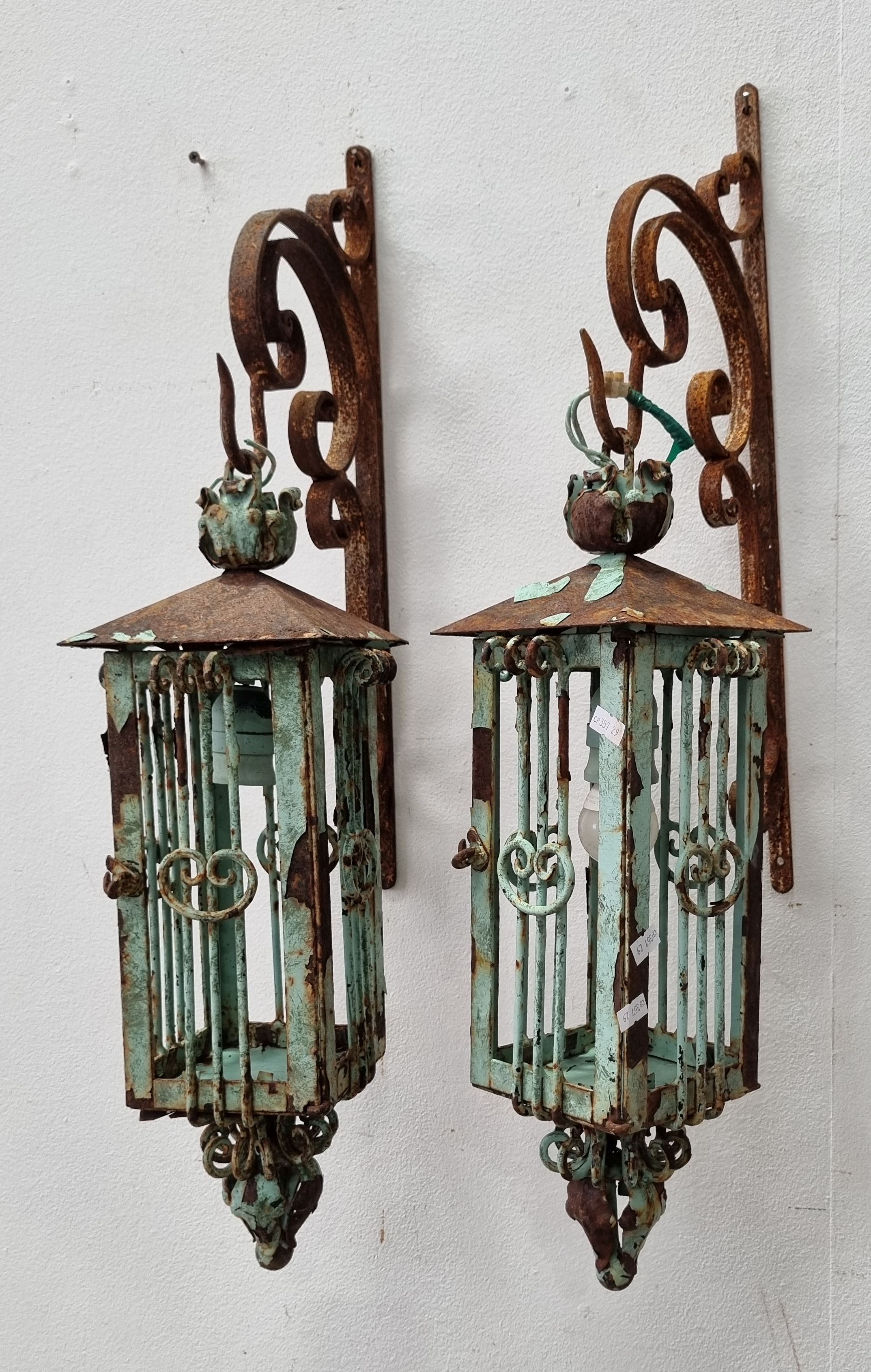 A Pair Of Wrought Iron Lanterns