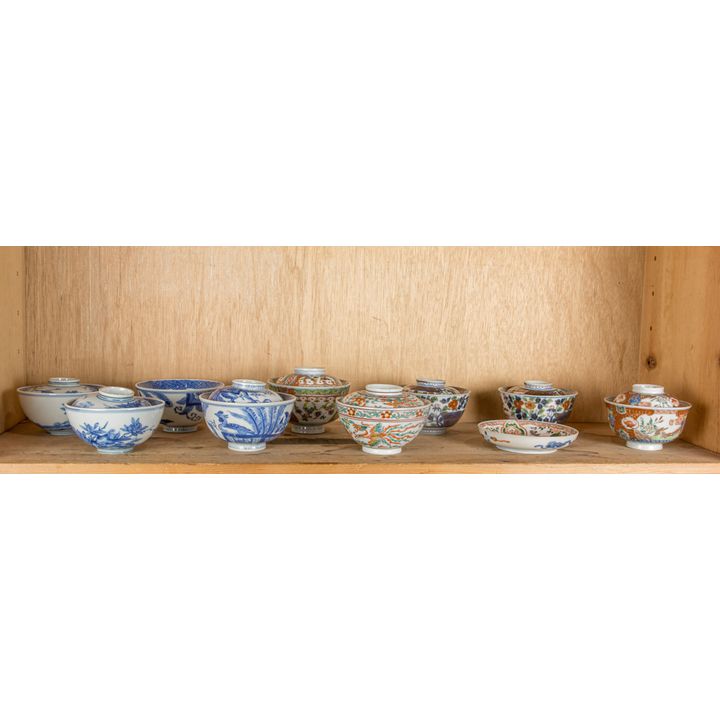 Shelf of Japanese covered porcelain bowls and dish