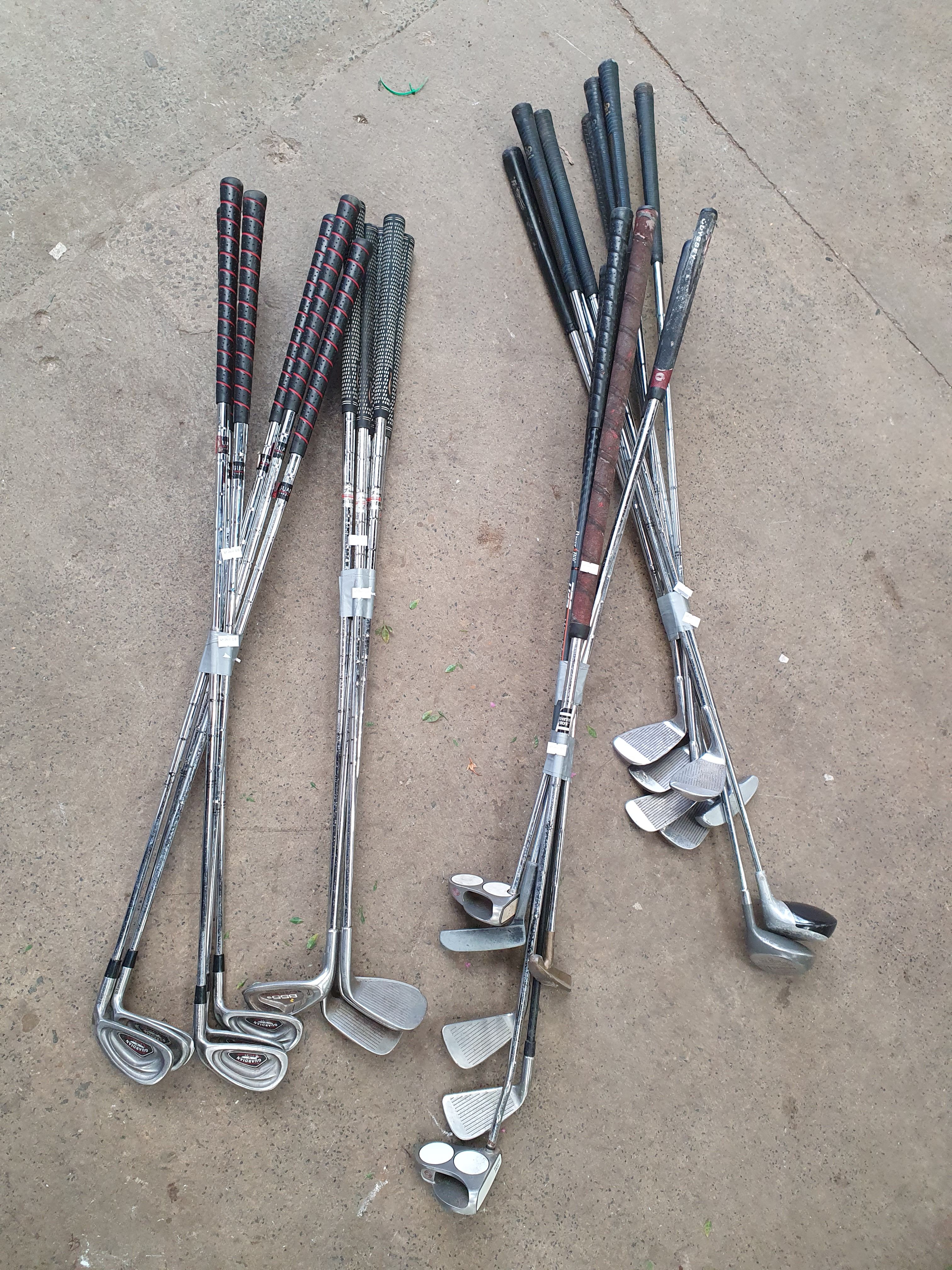 A LARGE GROUP OF GOLF CLUBS