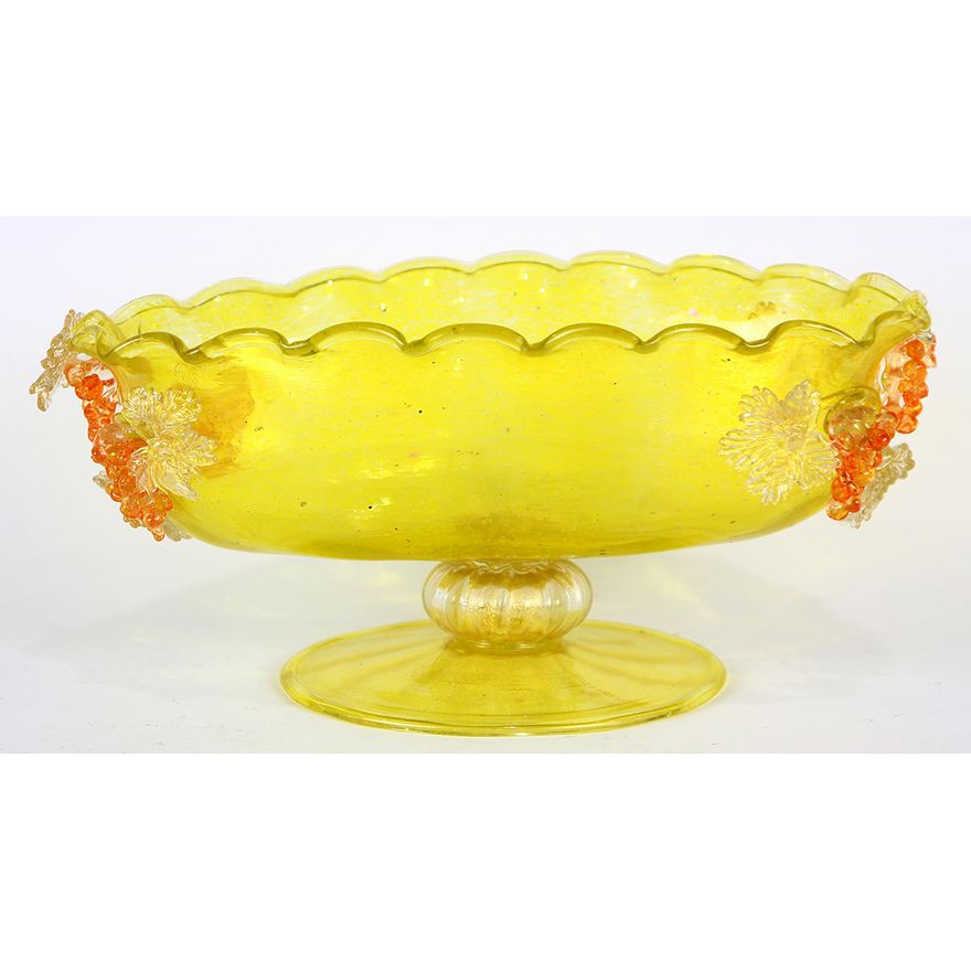 Italian Murano footed compote, having an oval form with grape cluster reserves, the body with gilt inclusions, and rising on a circu...