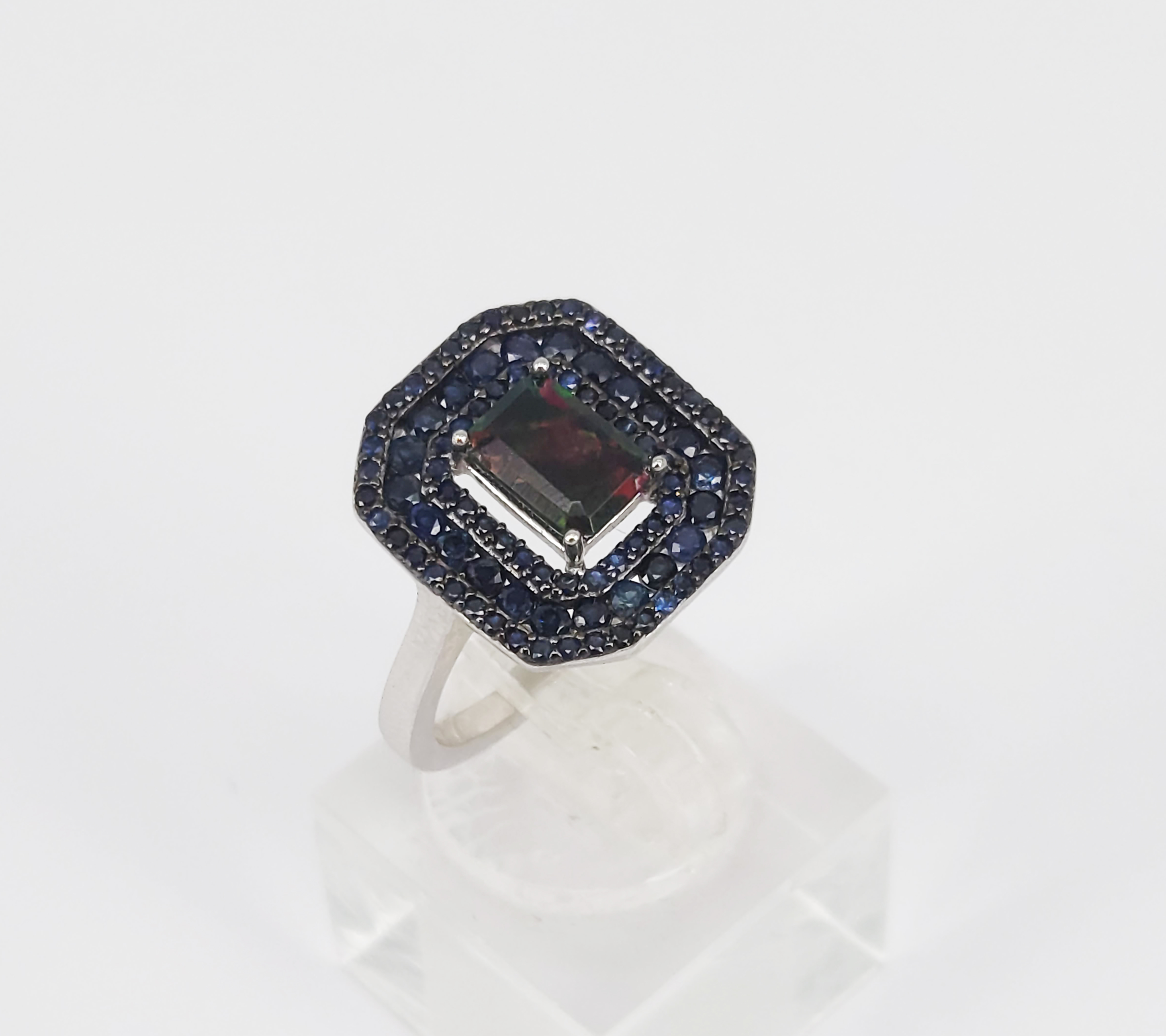 A Black Opal And Blue Sapphire Halo Dress Ring