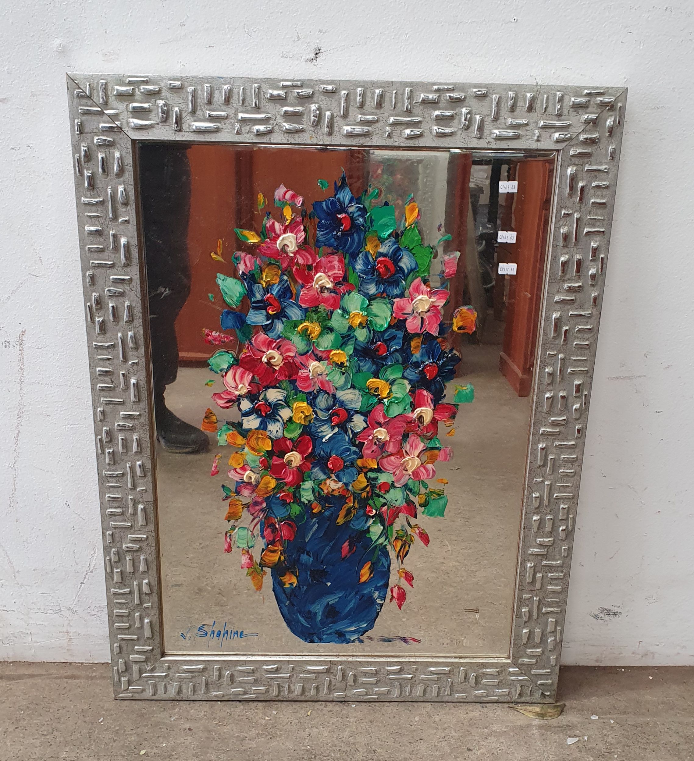 A DECORATIVE FRAMED MIRROR
