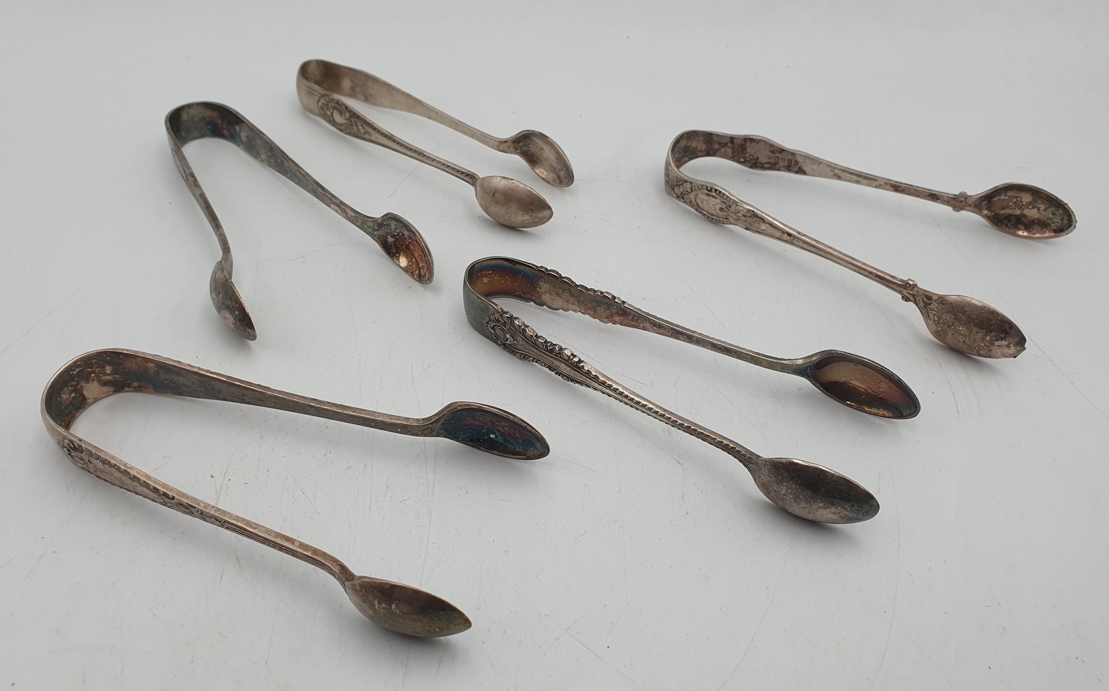 339 · FIVE PAIRS OF SILVERPLATED SUGAR TONS