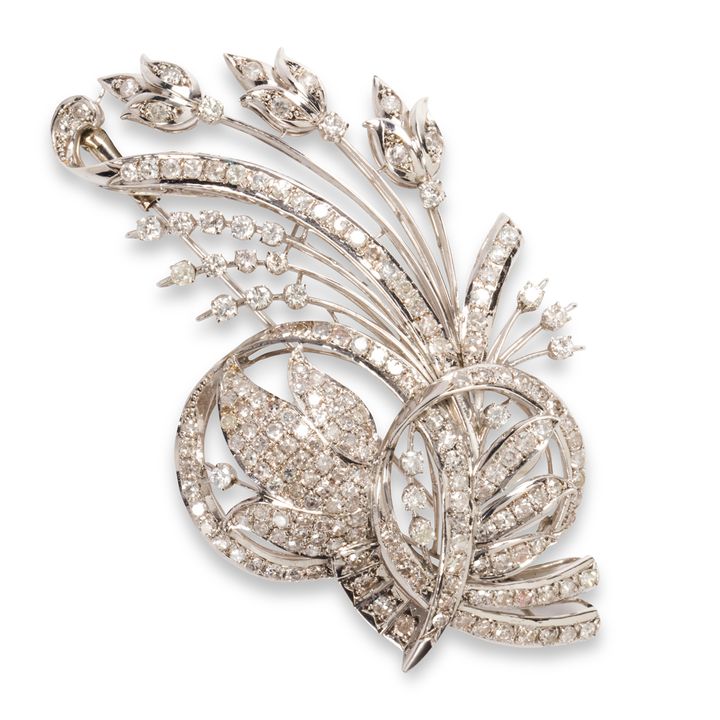 A diamond and fourteen karat white gold brooch