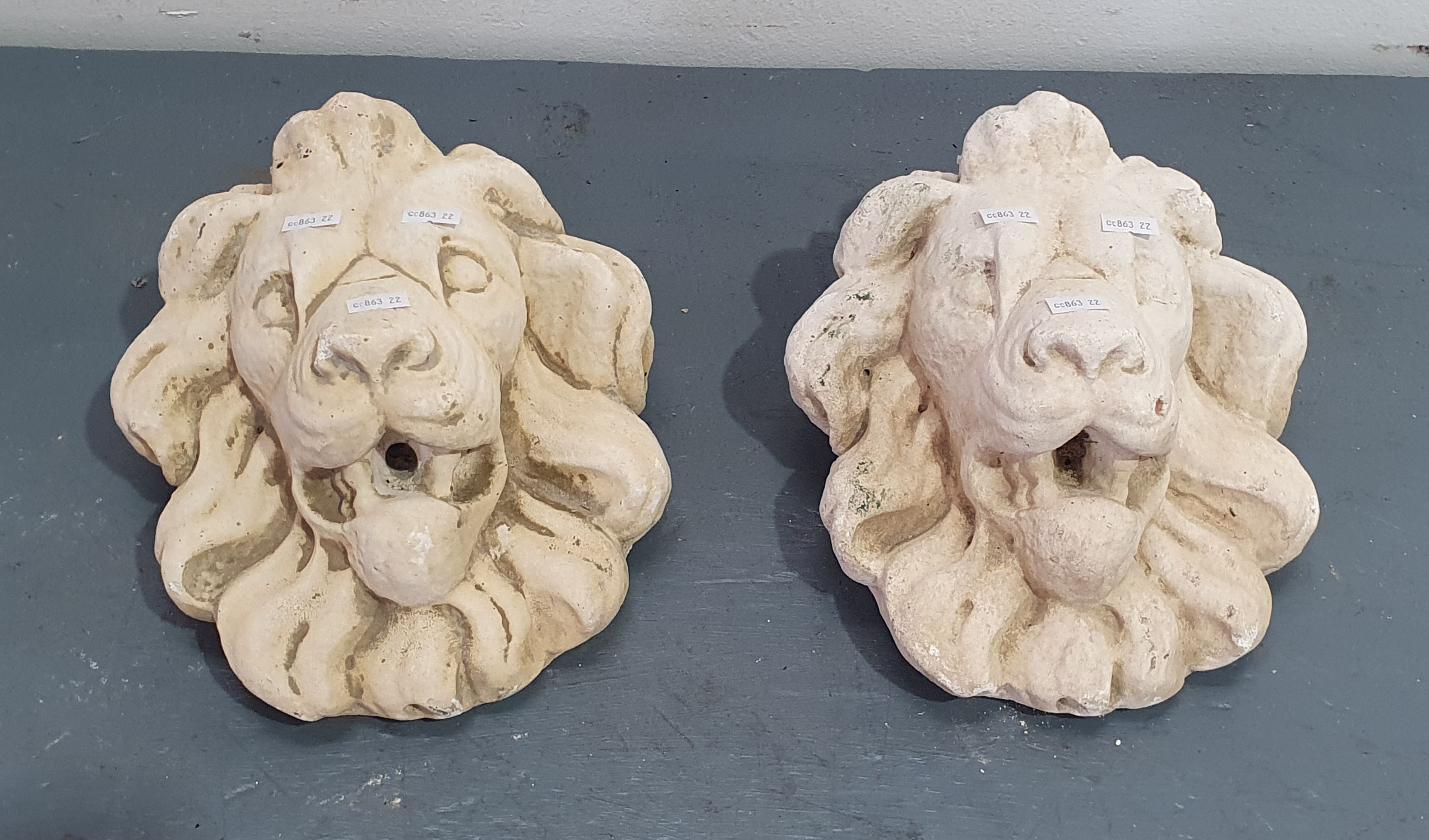 1137A · A PAIR OF HANGING CONCRETE LION HEADS