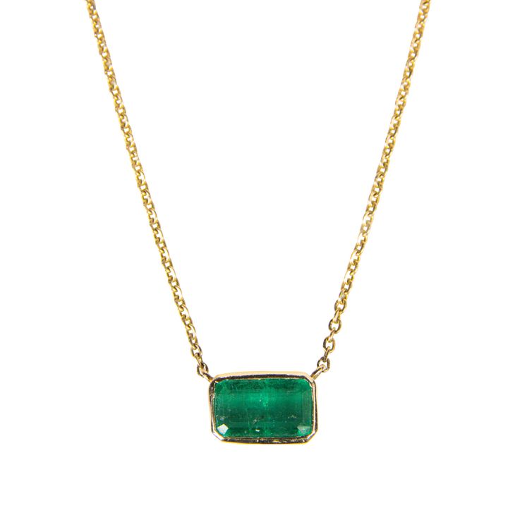 An emerald and 14k gold pendant necklace