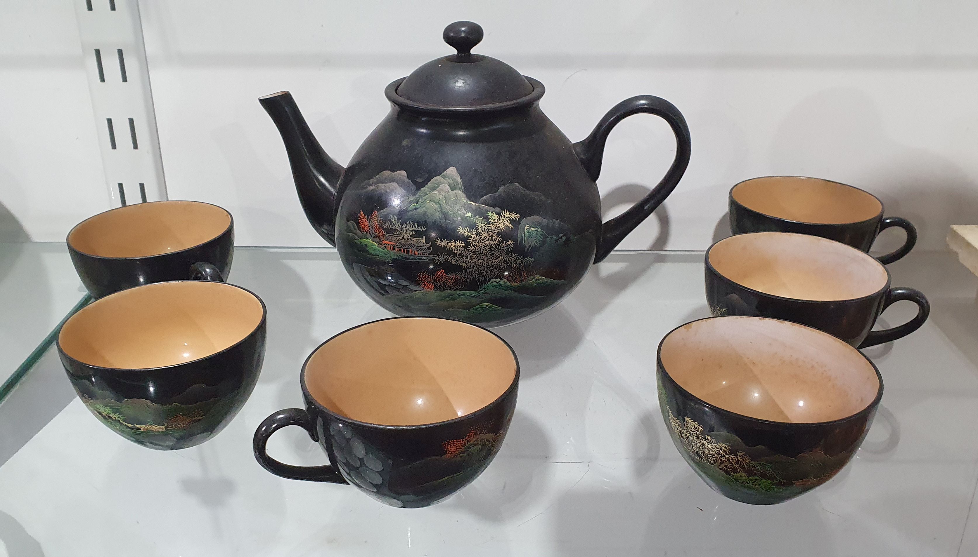 180 · A LACQUER LOOK TEAPOT AND SIX CUPS