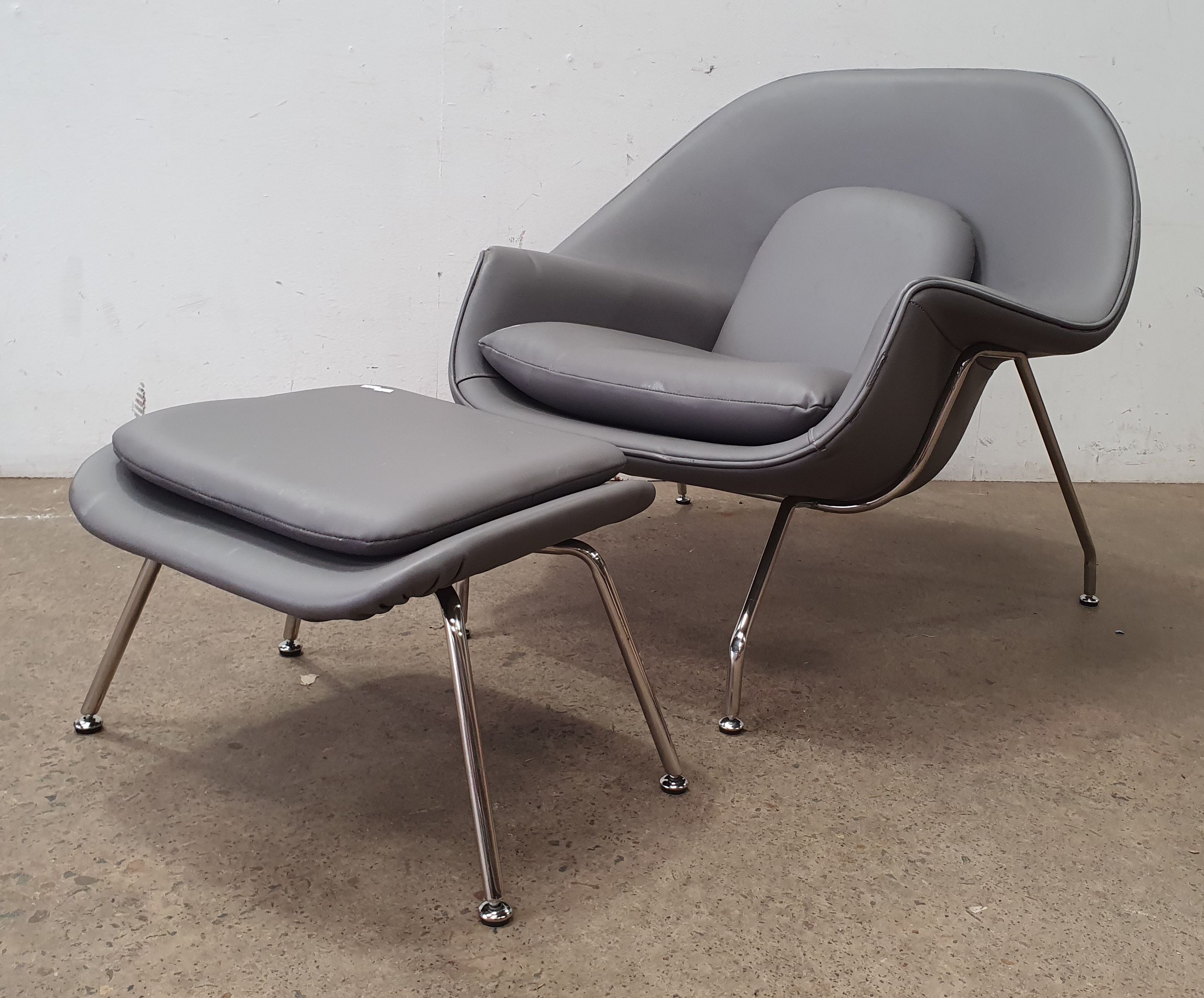A Leather Womb Chair And Footrest