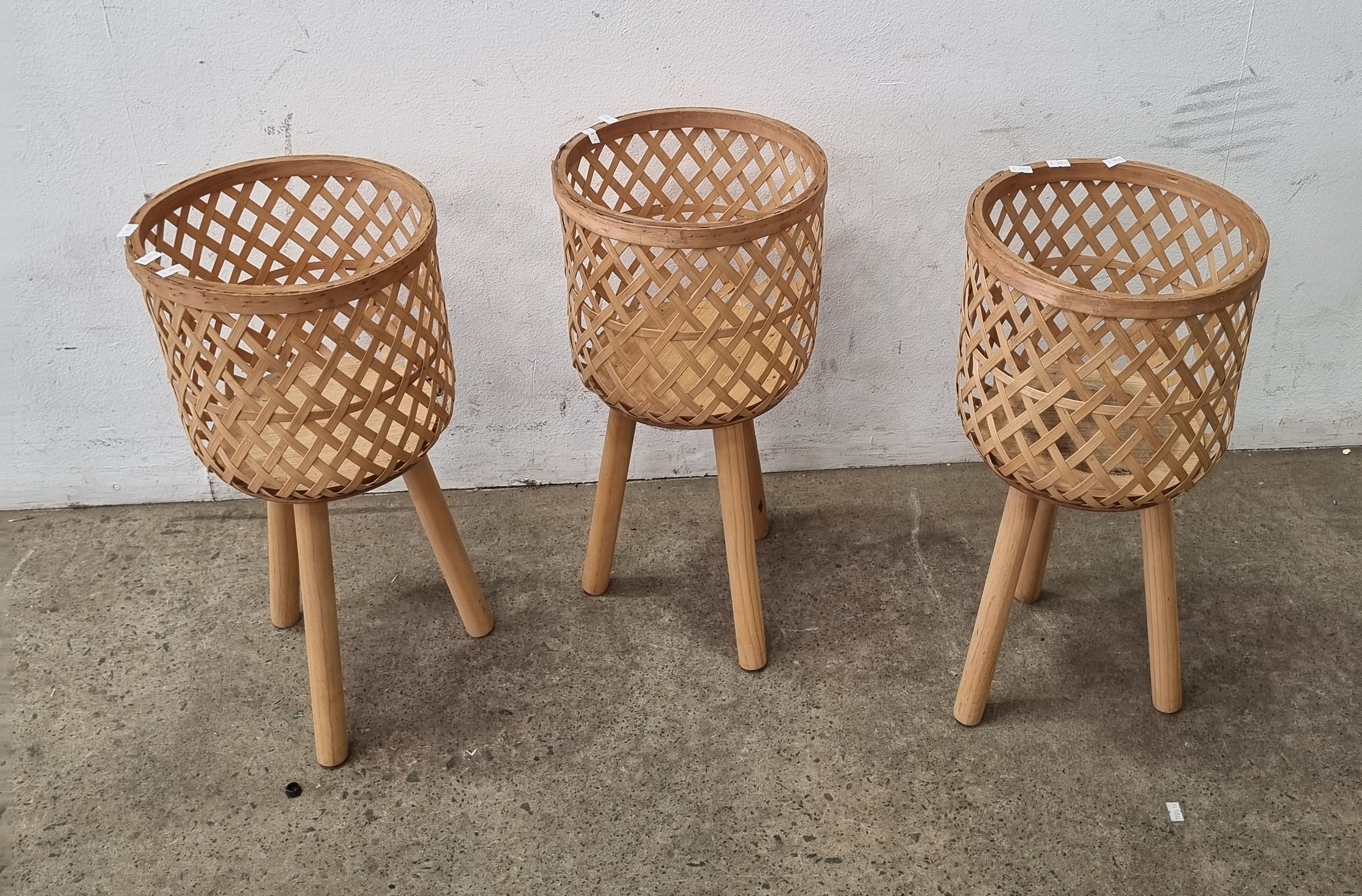 1022 · A TRIO OF CANE POT STANDS