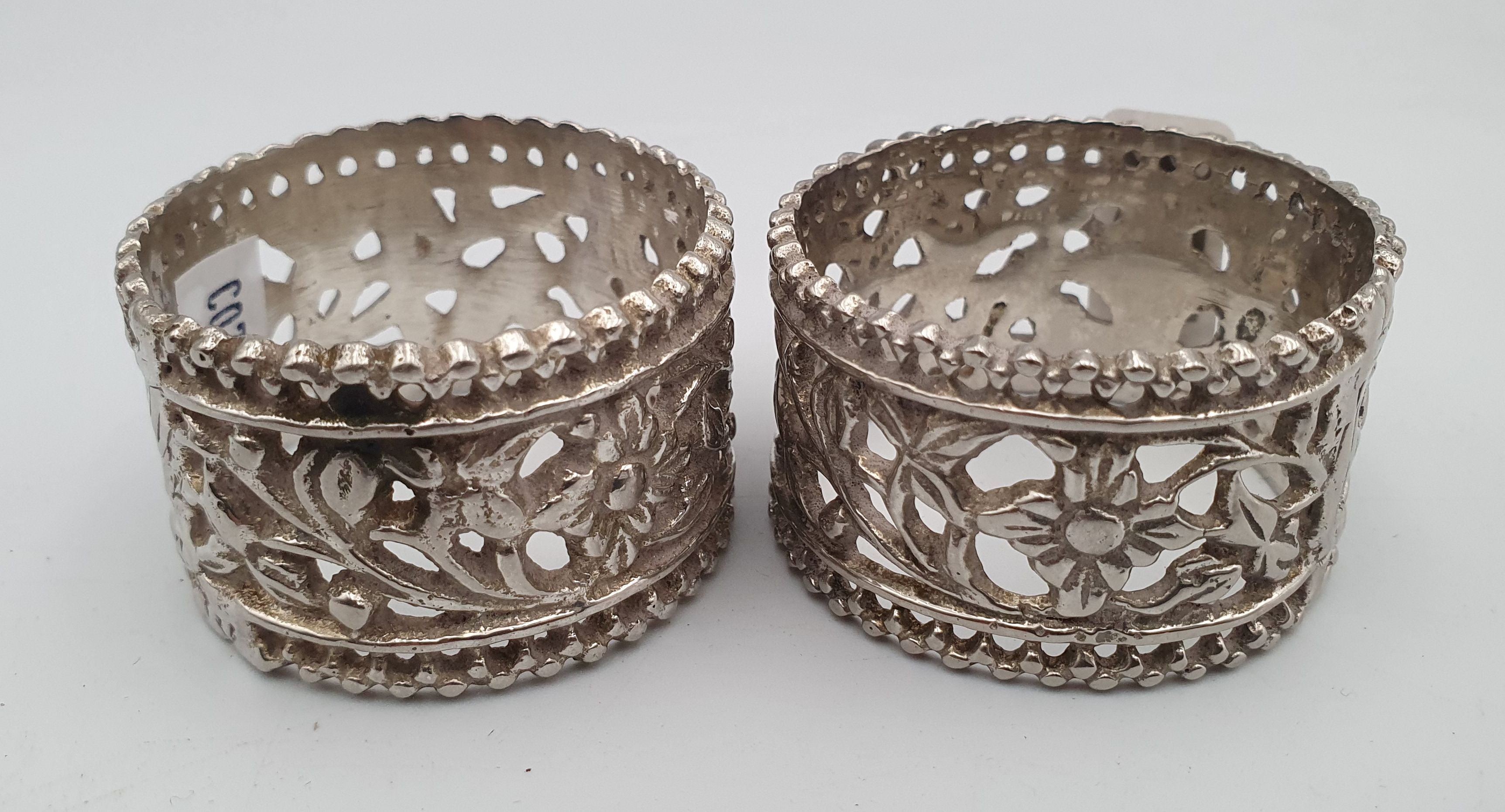 A PAIR OF INDIAN PIERCED SILVERPLATED NAPKIN RINGS
