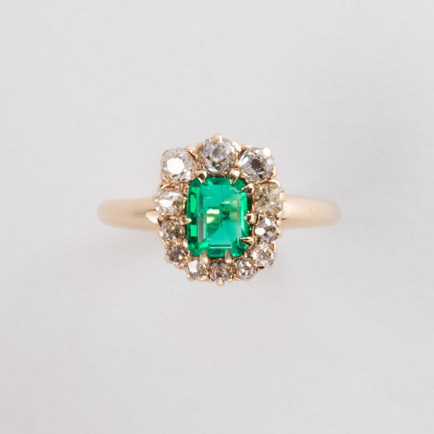 An emerald, diamond and fourteen karat gold ring