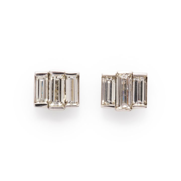 A pair of diamond and fourteen karat white gold earrings