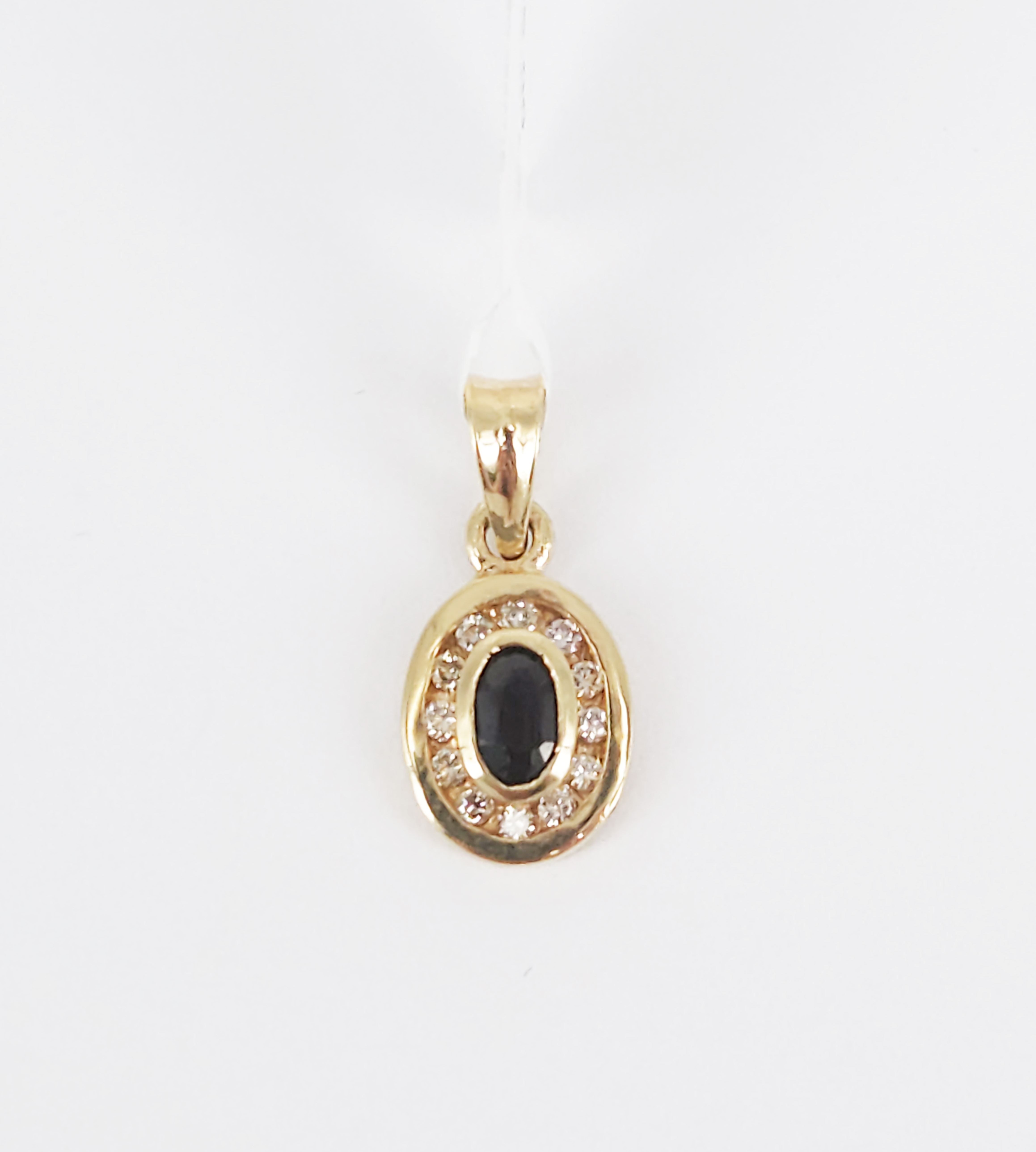 A 9ct Yellow Gold Oval Sapphire And Natural Diamond Halo Pendant