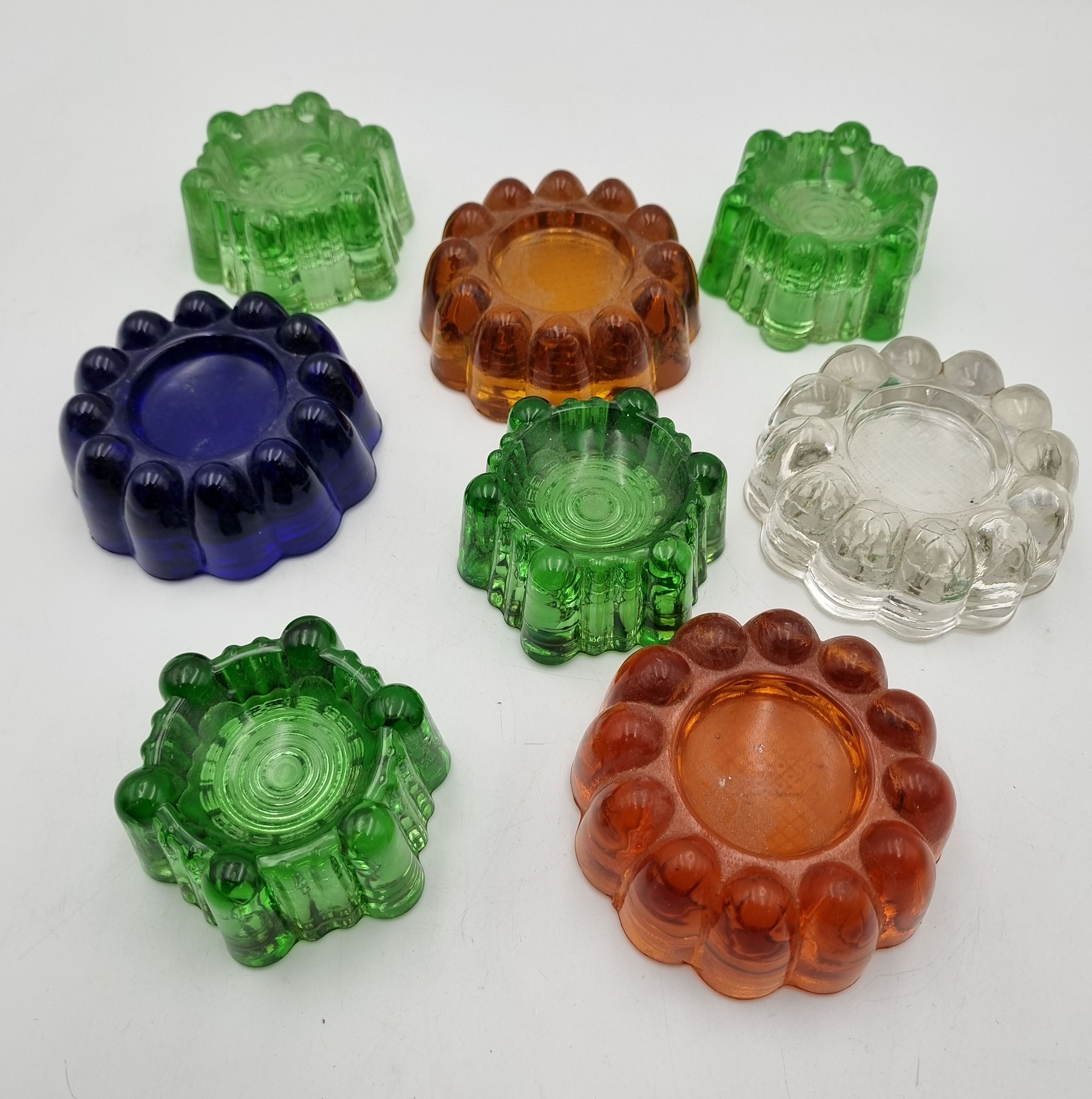 613 · FOUR VINTAGE GREEN GLASS CASTER CUPS