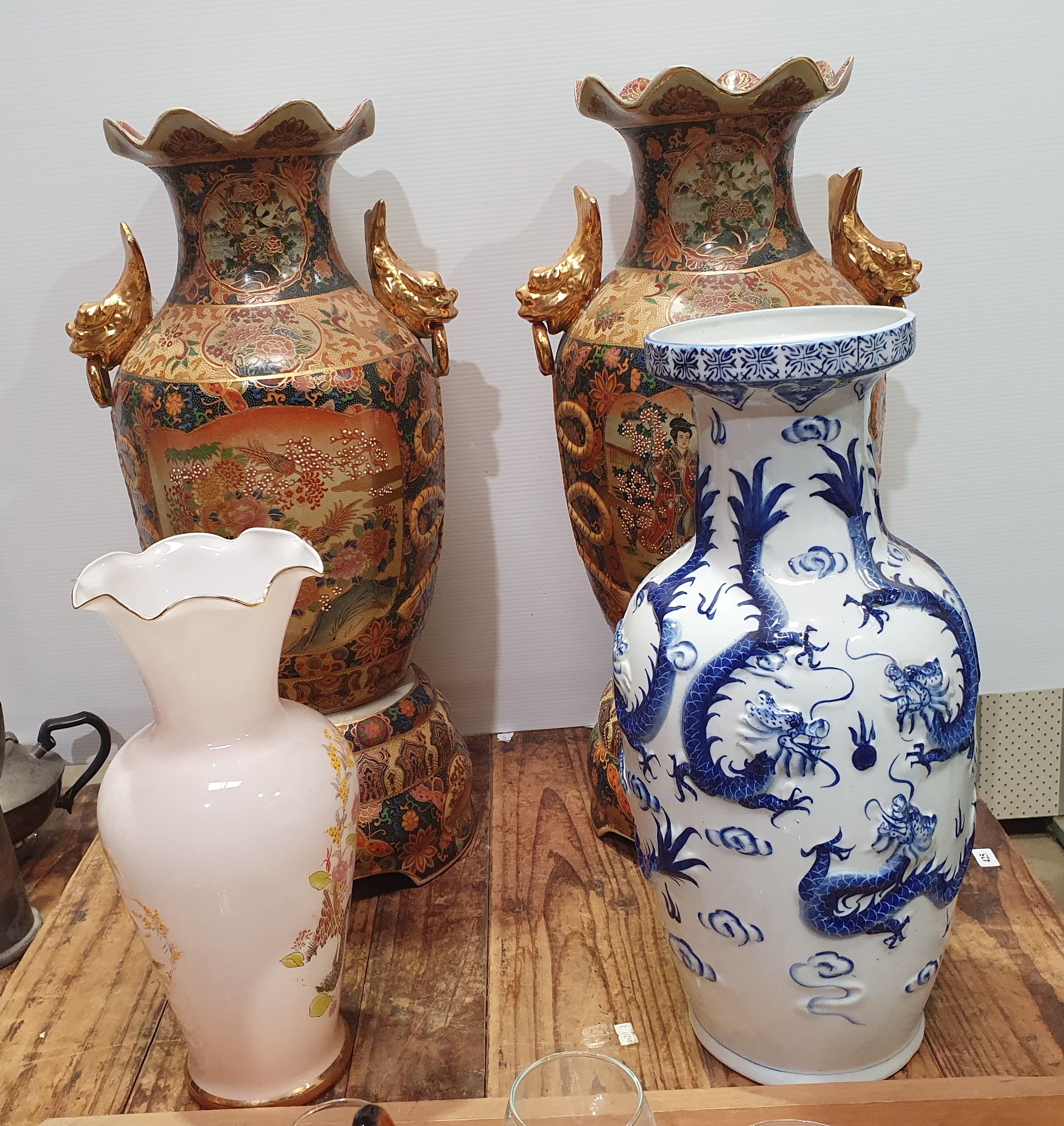 A PAIR OF ASIAN EXPORT VASES ON STANDS