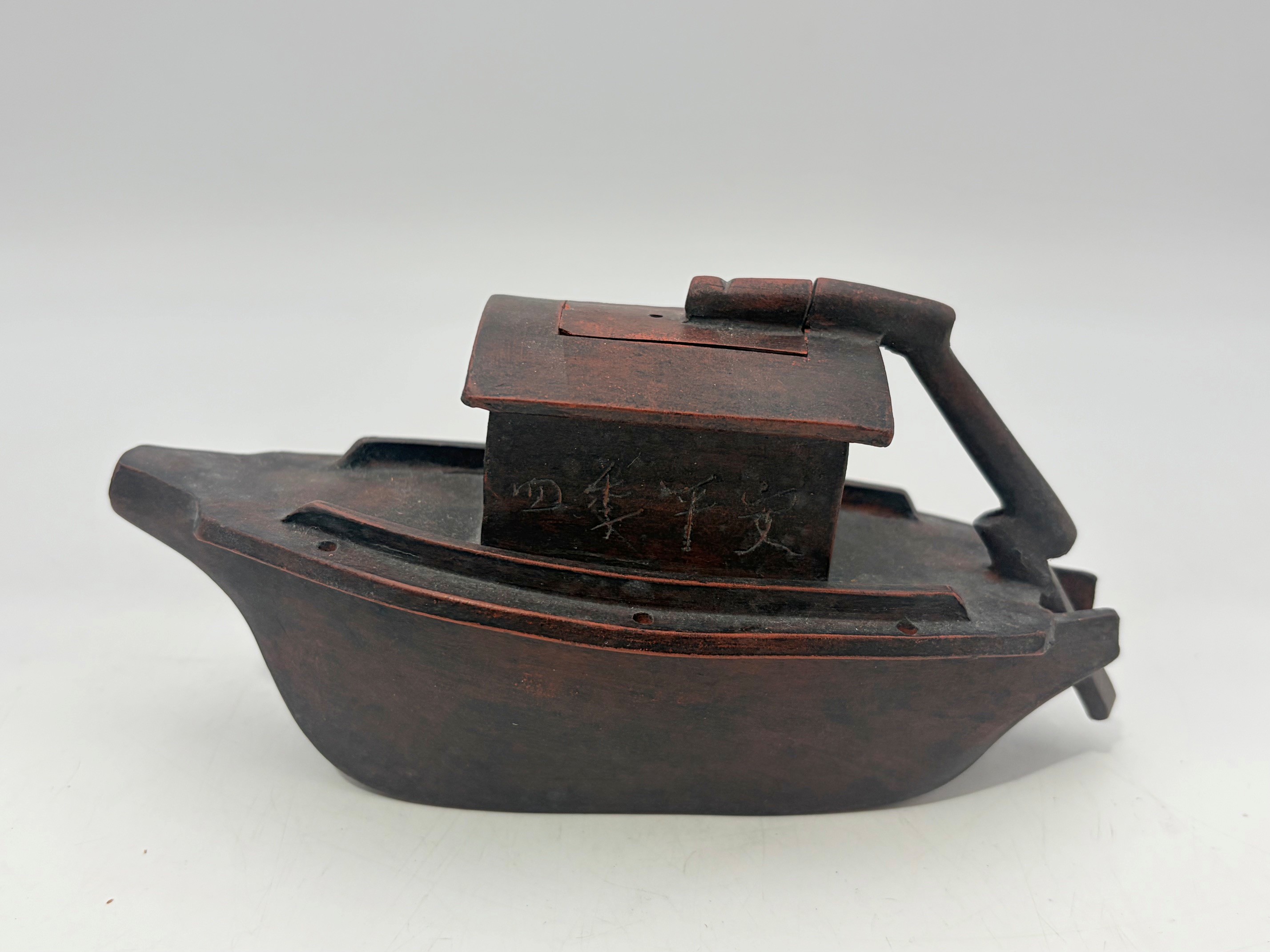 A Chinese Yixing Zisha Boat Shaped Teapot