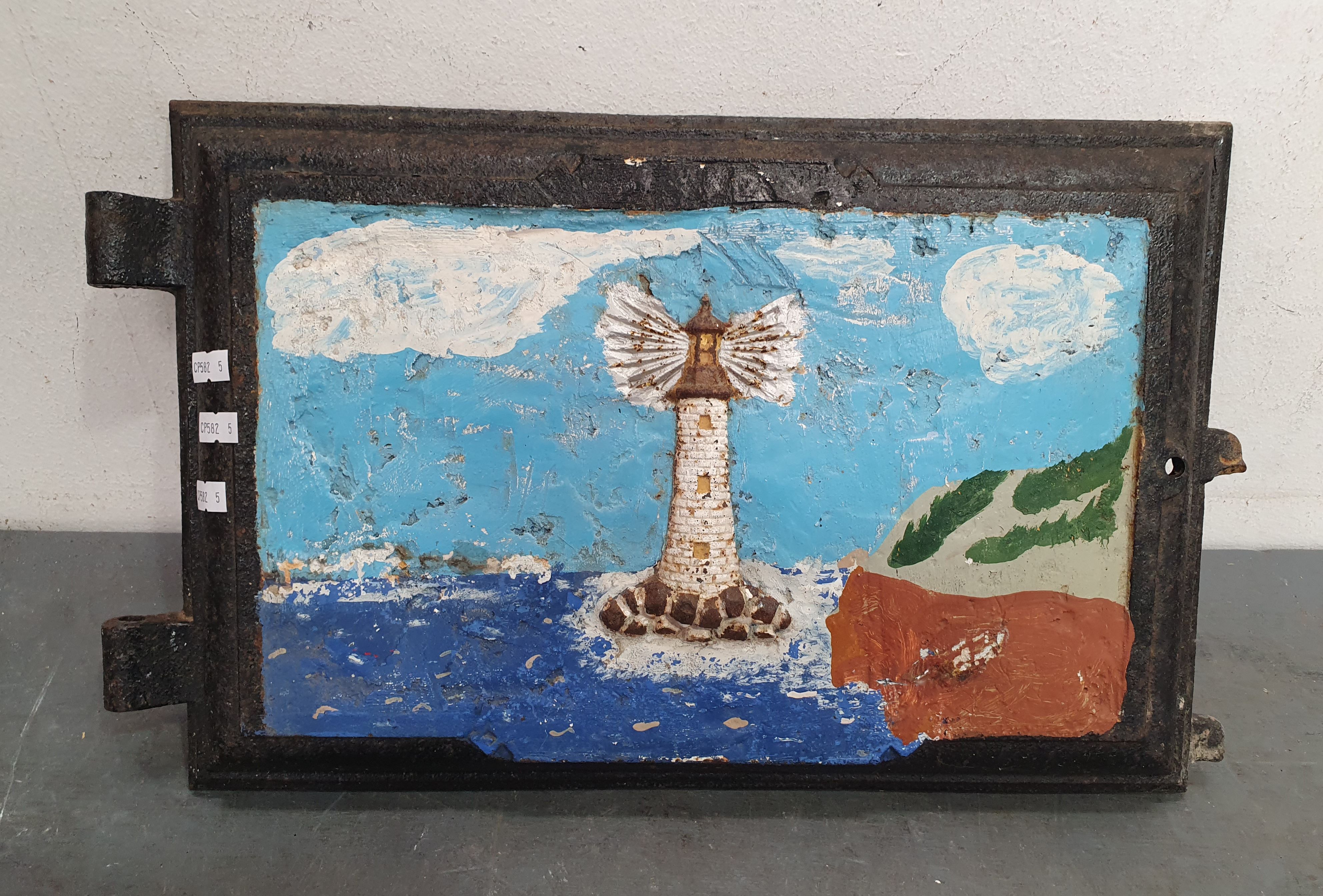 1129 · A LIGHTHOUSE PAINTED ON CAST IRON STOVE DOOR