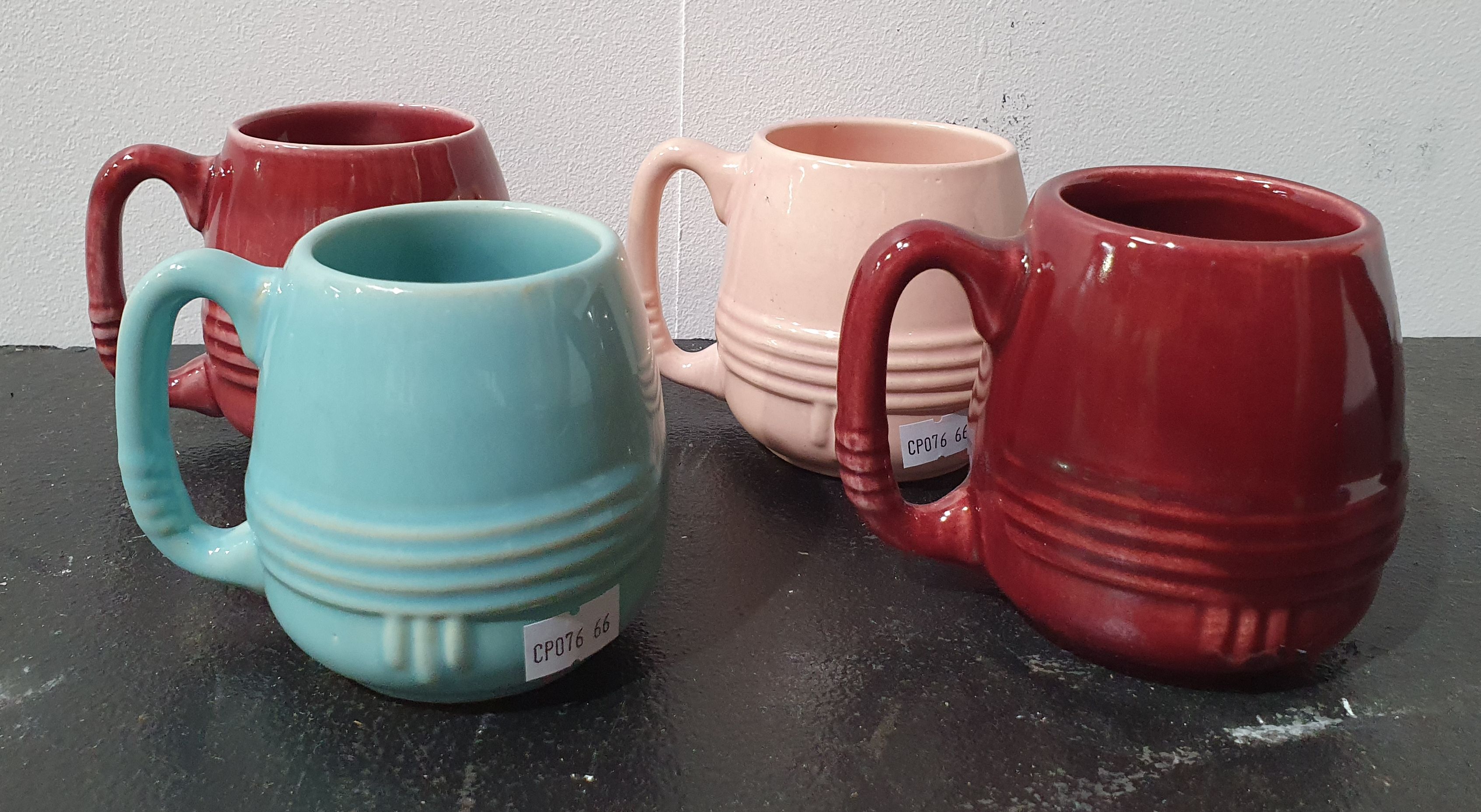 438 · A GROUP OF FOUR MCP ART DECO MUGS