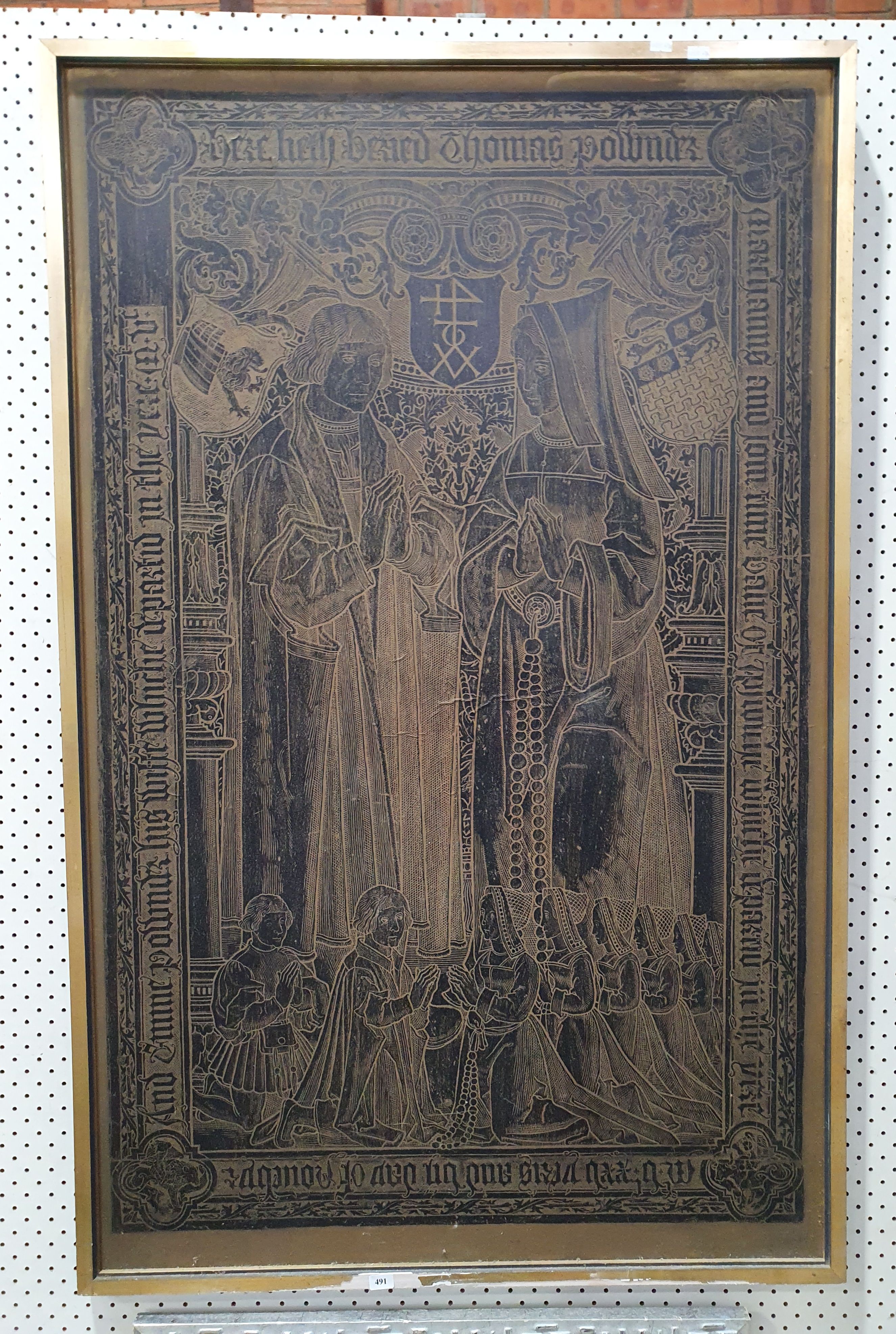 A FRAMED BRASS RUBBING