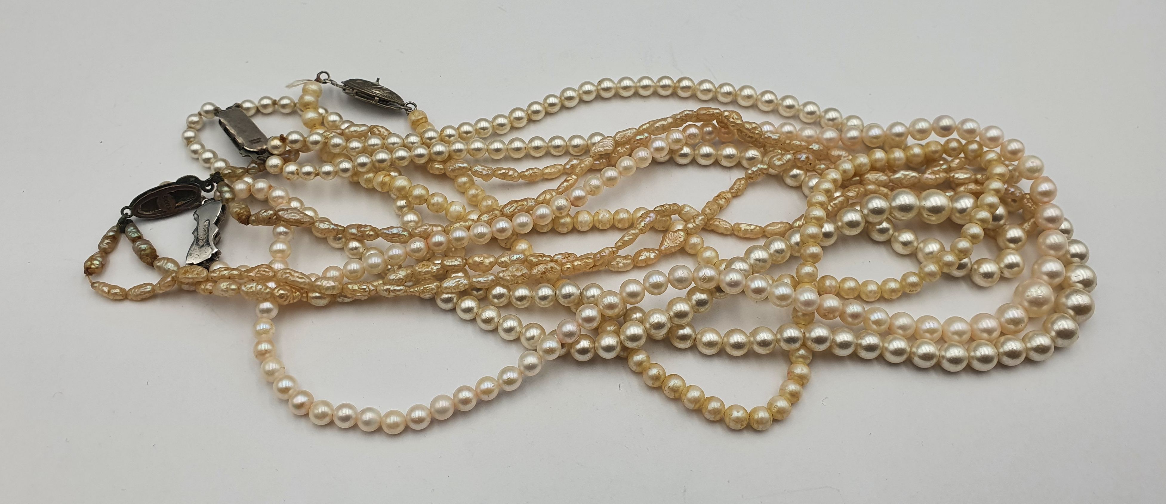 287 · FOUR PEARL NECKLACES WITH SILVER CLASPS