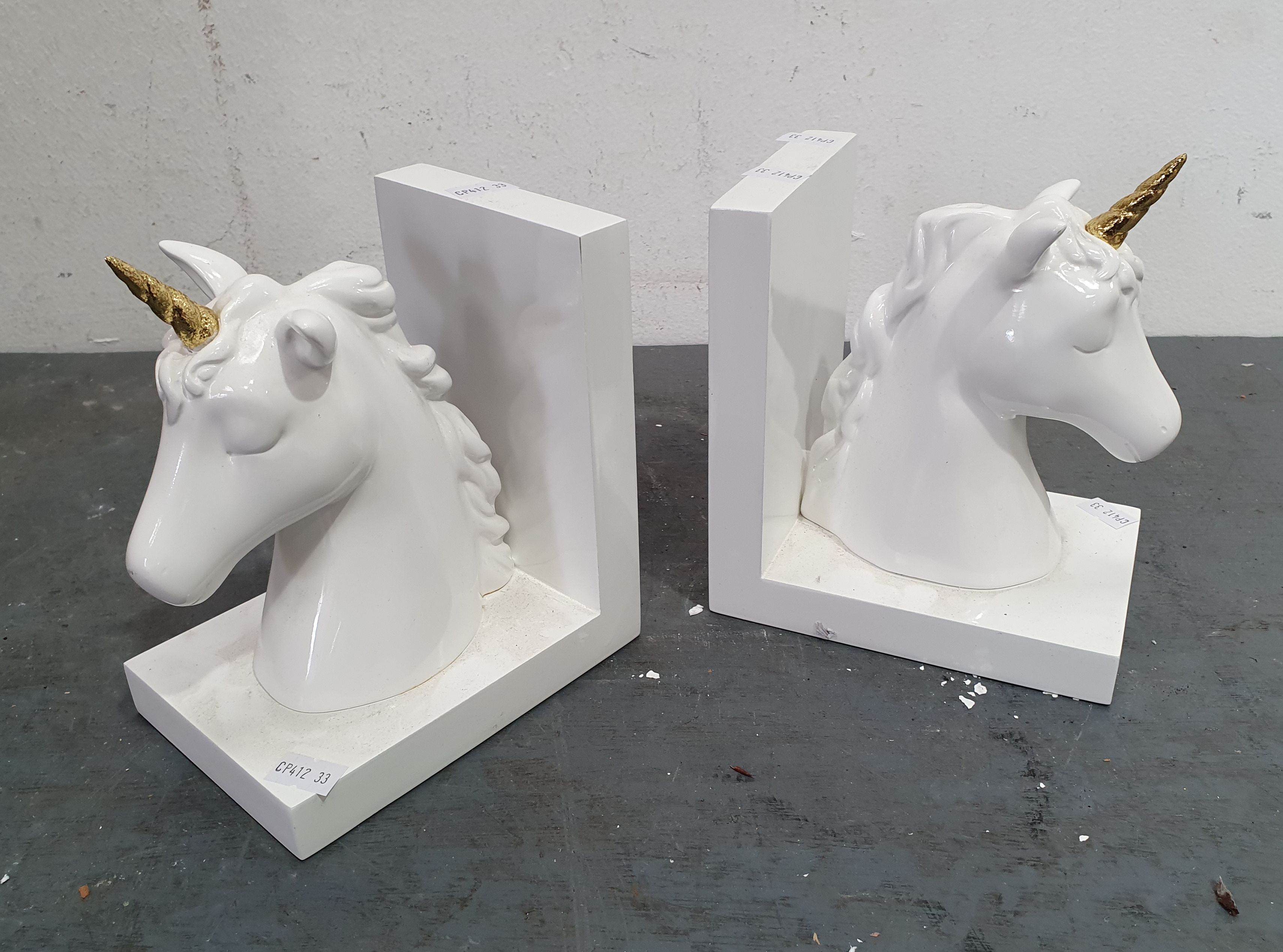 1432 · A PAIR OF POTTERY BARN UNICORN BOOKENDS