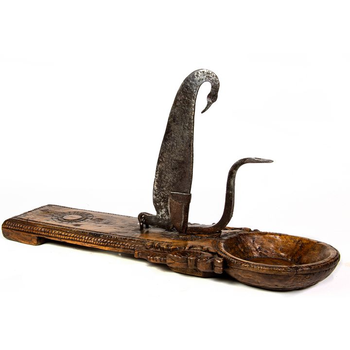 An Indian carved hardwood coconut cutter with iron blade