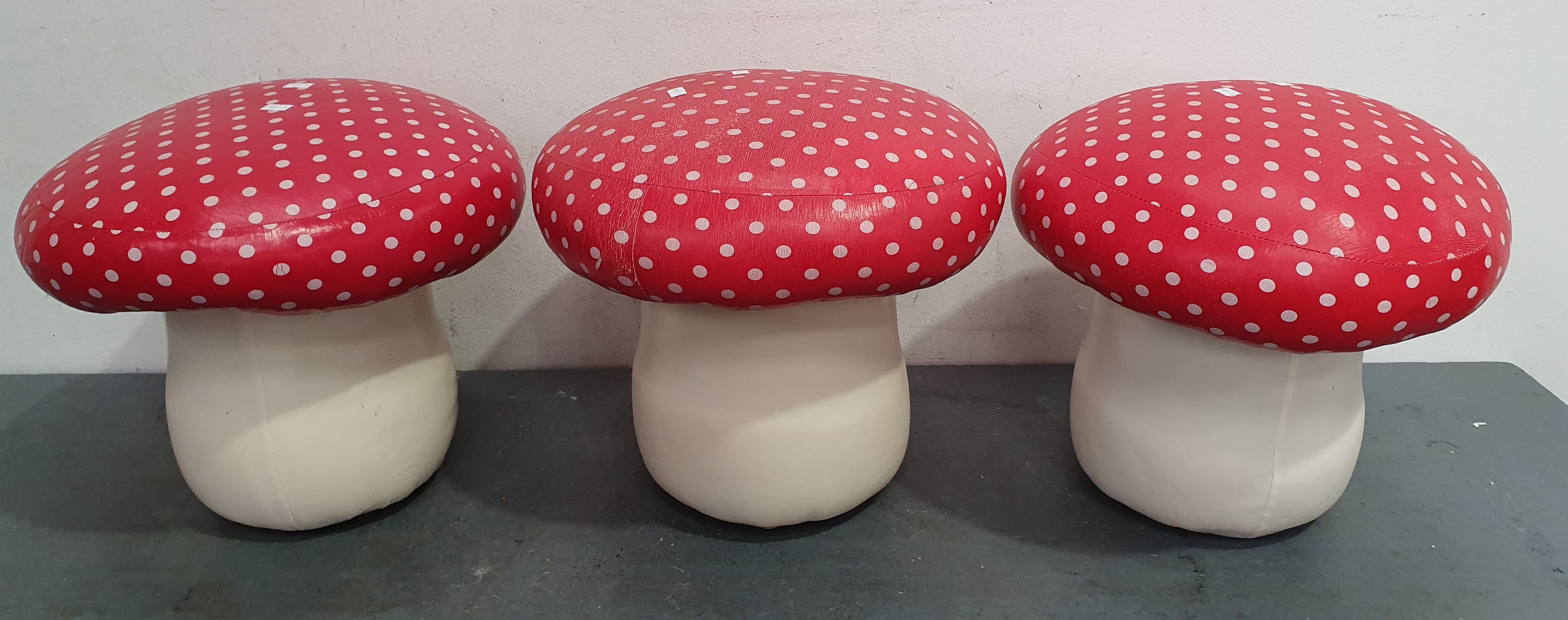 2468 · A SET OF THREE MUSHROOM FORM STOOLS