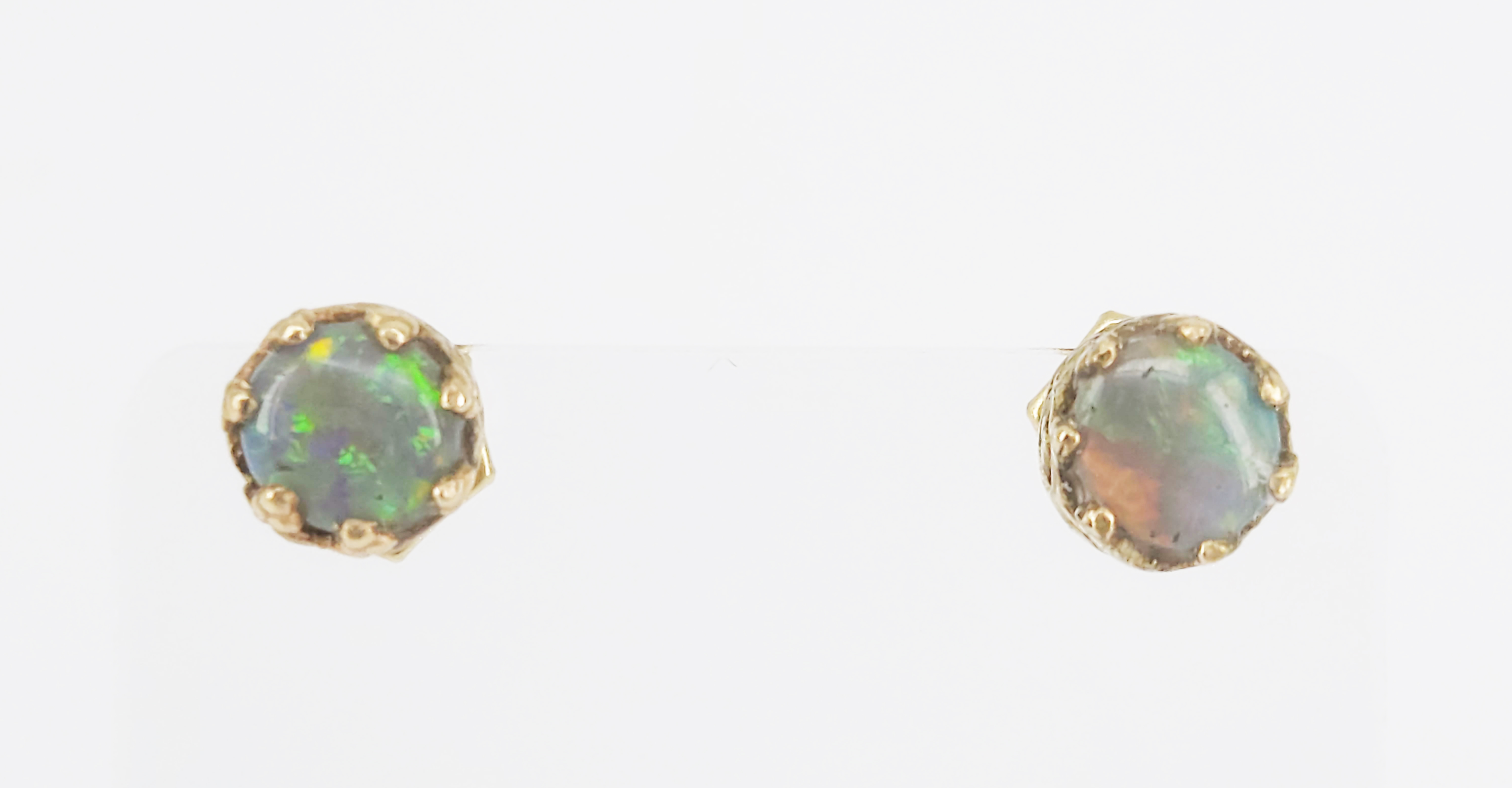 A Pair Of 14ct Gold And Solid Black Opal Stud Earrings