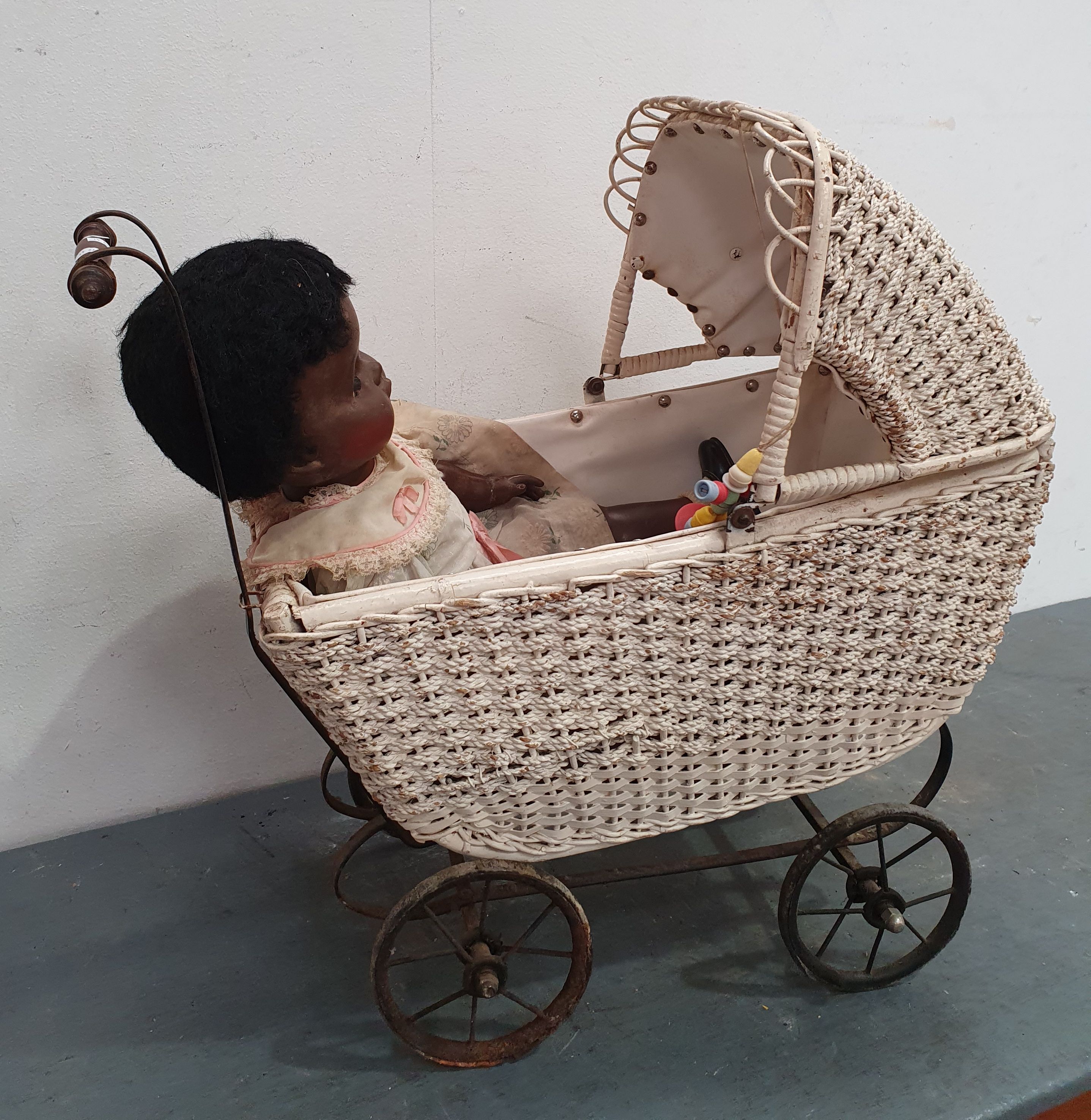 A CANE AND WROUGHT IRON BABY DOLL PRAM