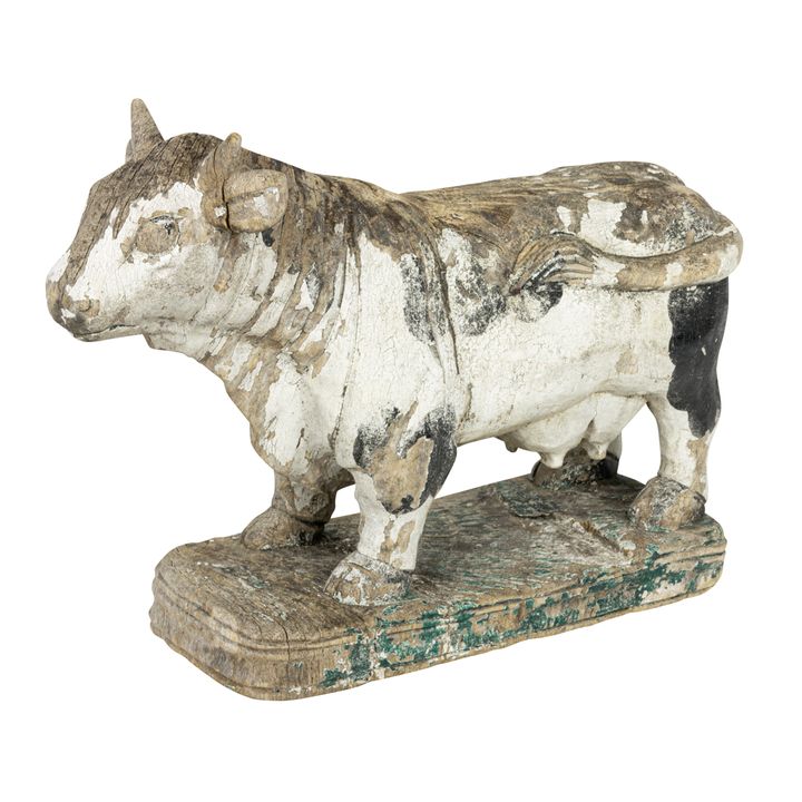 A European carved wood figure of a Holstein cow with traces of polychrome