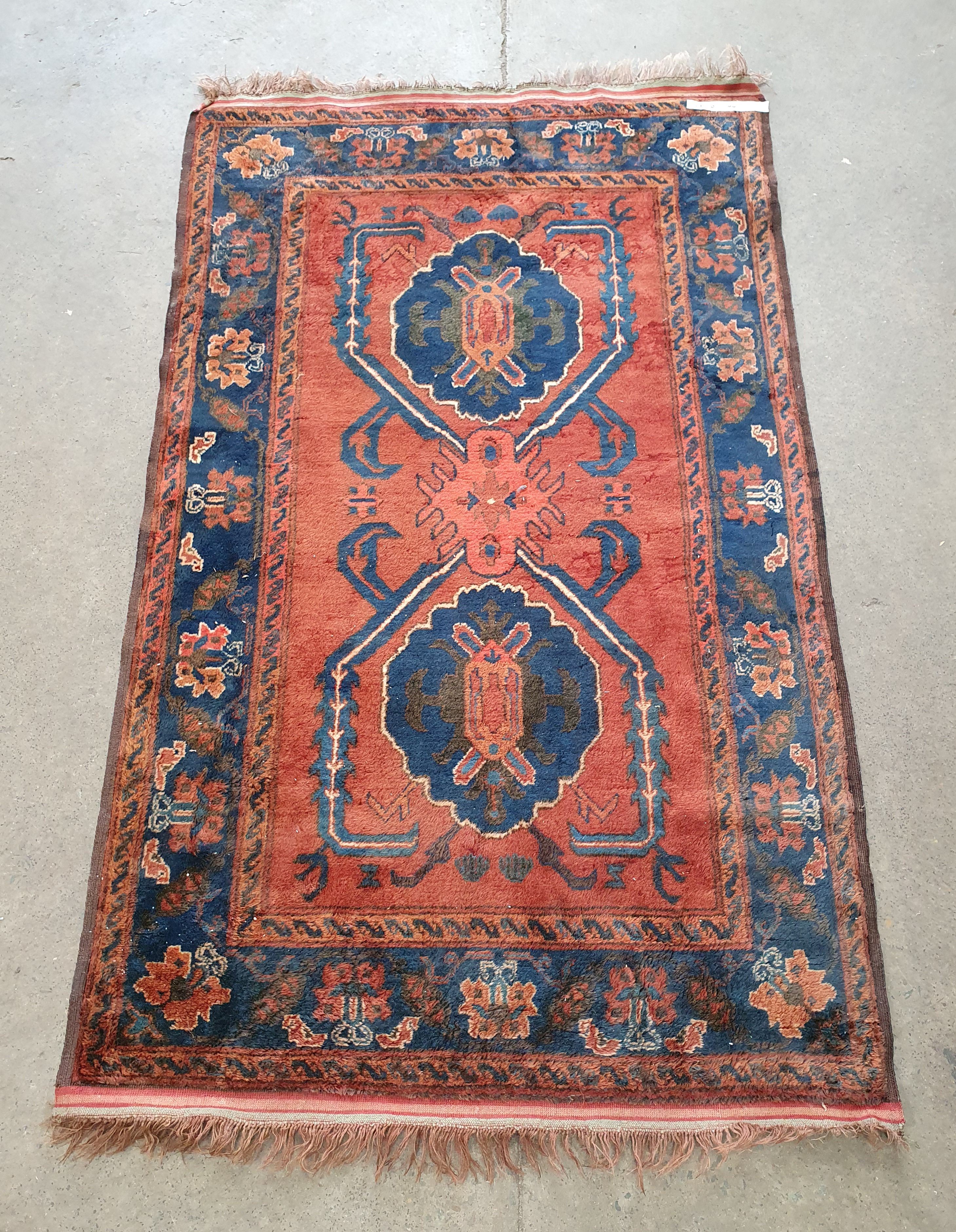 A HANDMADE BROWN RUG