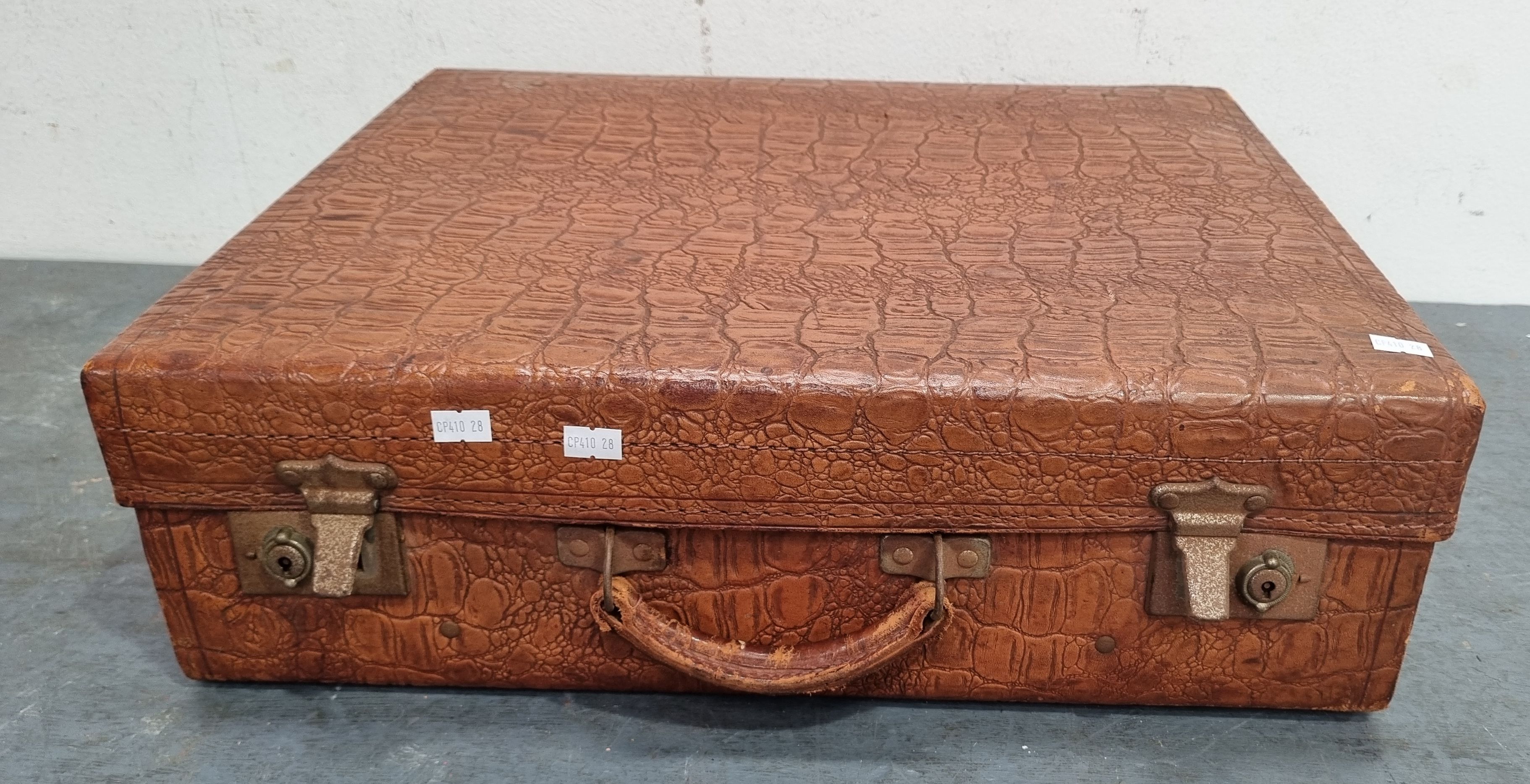 1336 · A LEATHER SUITCASE