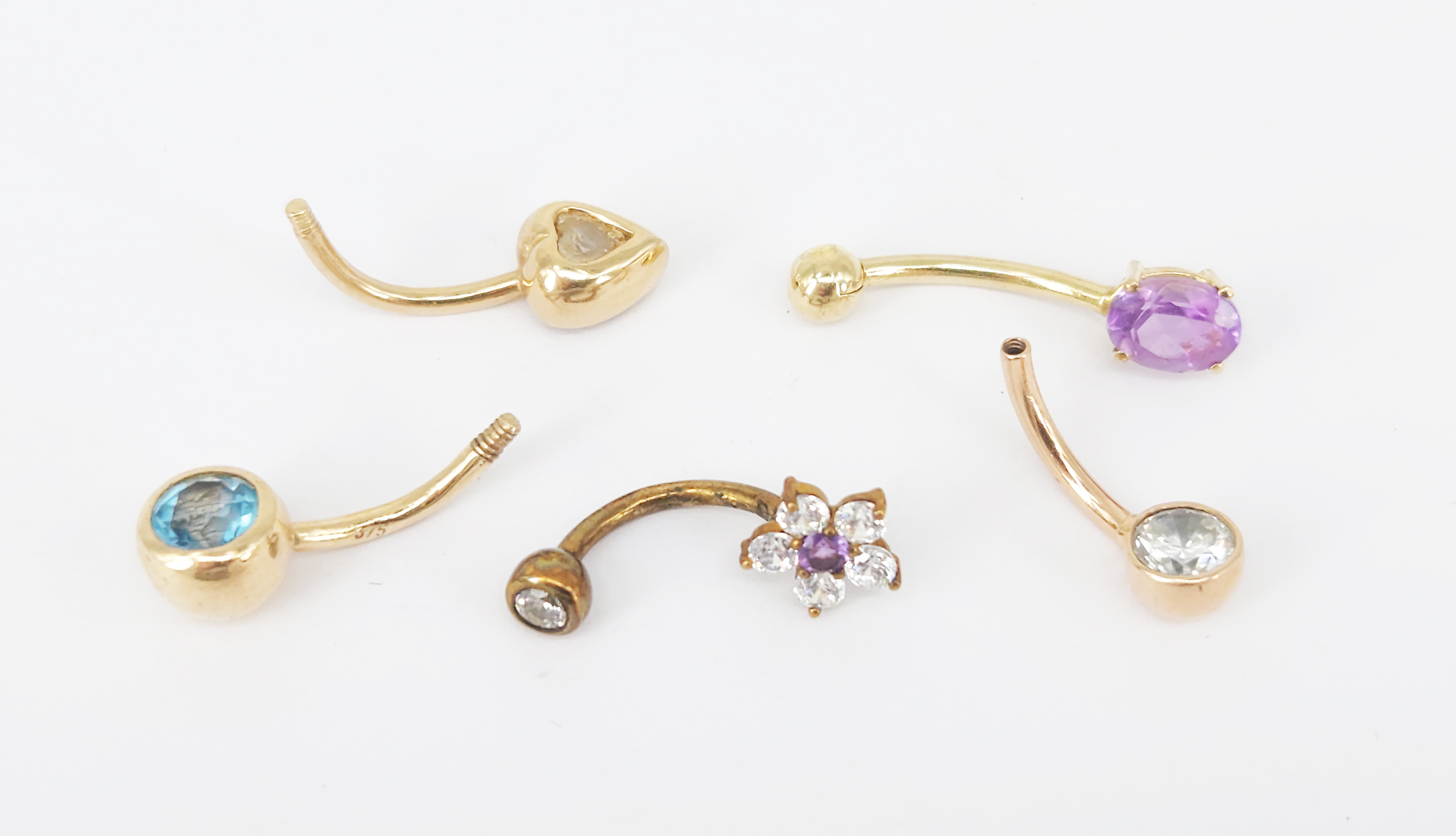 242 · FIVE GOLD AND STONE-SET BELLY RINGS