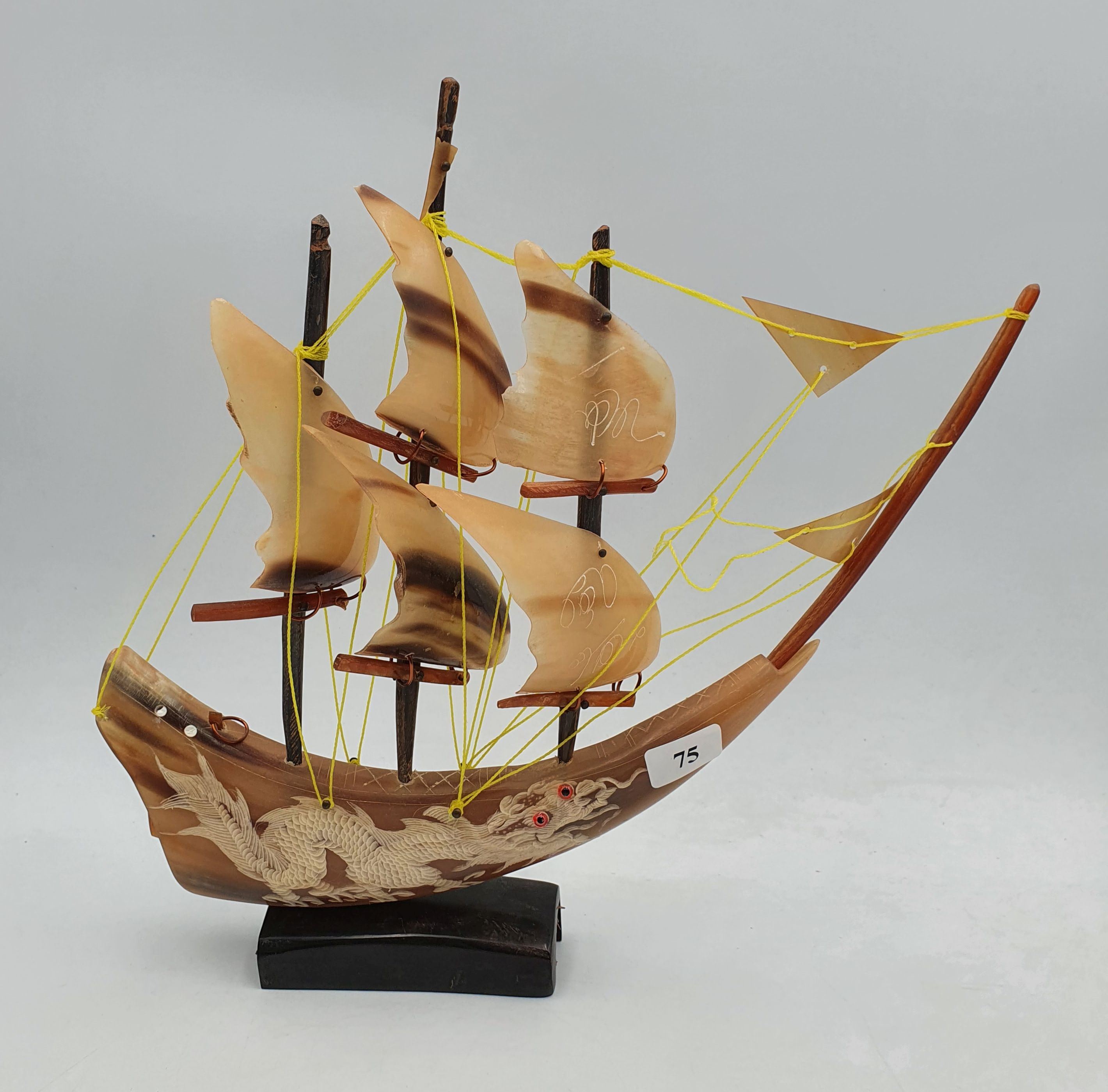 75 · A CARVED HORN SHIP WITH DRAGON MOTIF