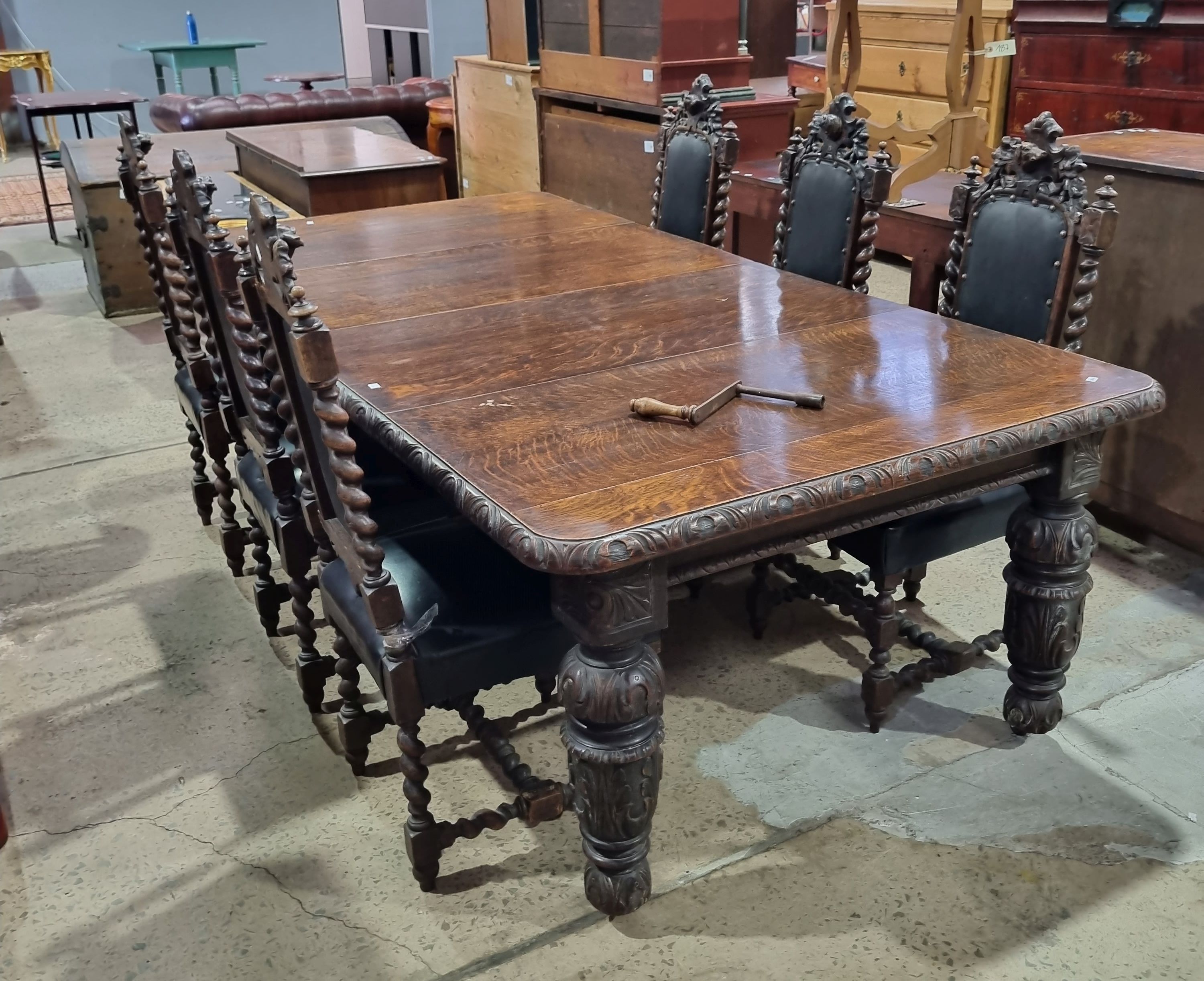 A VICTORIAN CARVED OAK SEVEN PIECE DINING SUITE