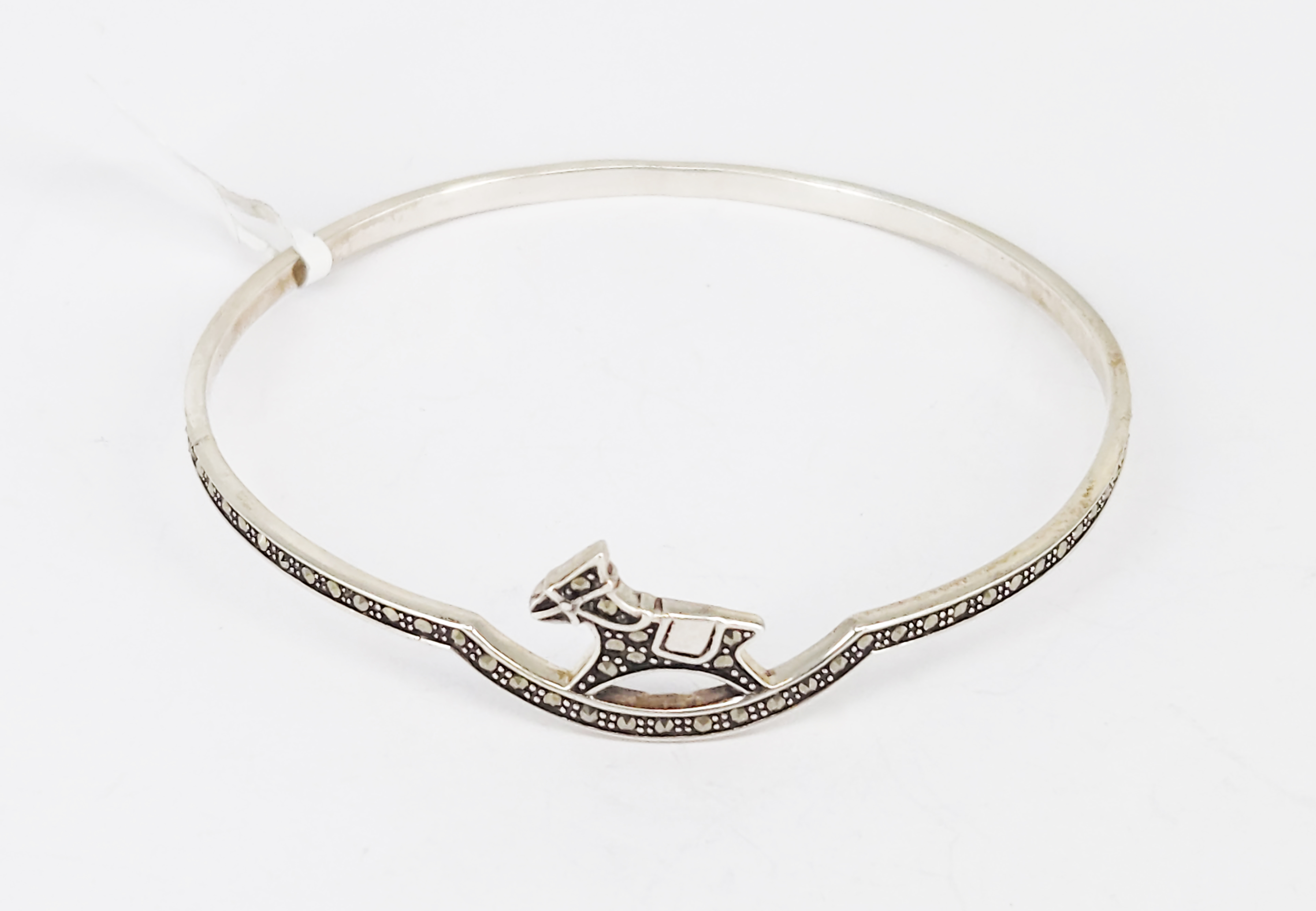 366 · A STERLING SILVER AND MARCASITE ROCKING HORSE BANGLE