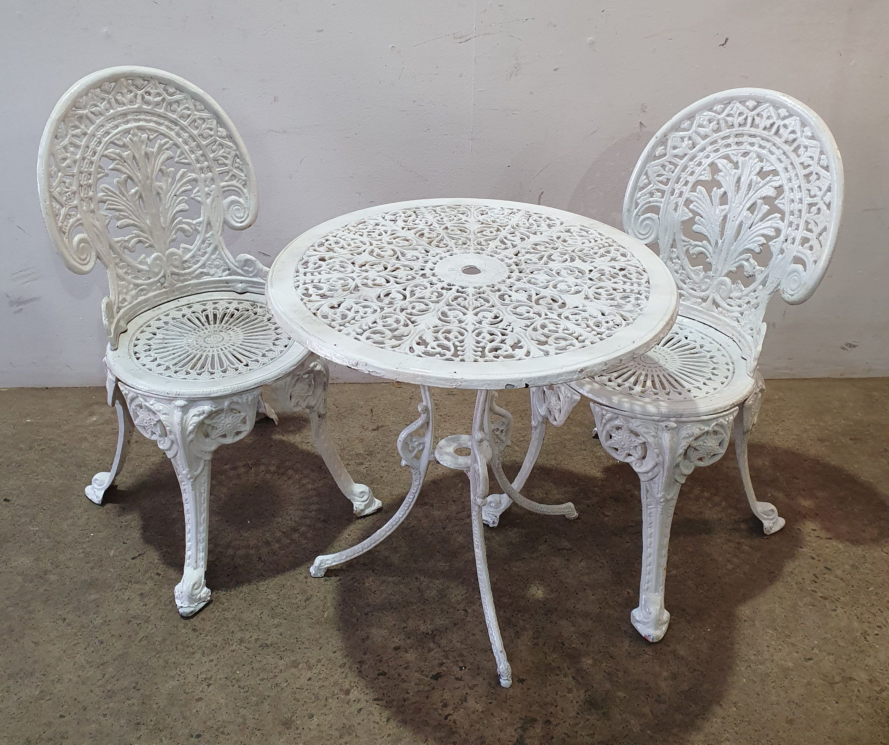 A Cast Iron Three Piece Garden Setting