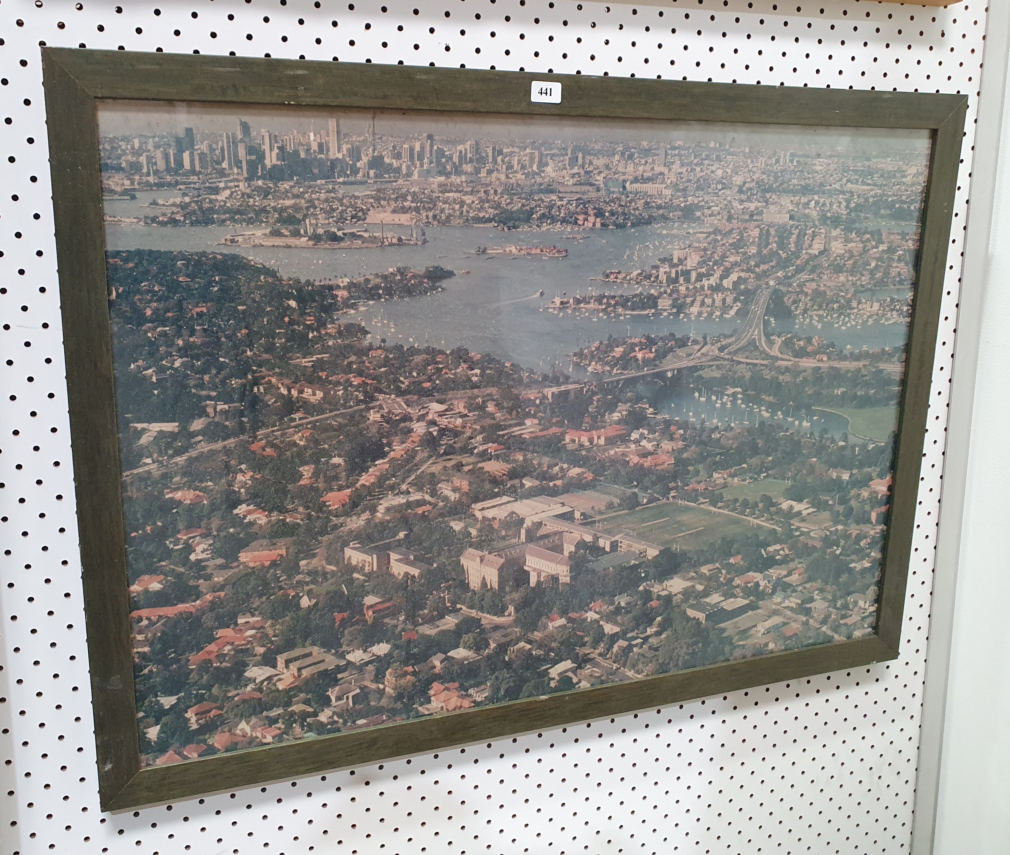 A FRAMED COLOURED AERIAL PHOTOGRAPH OF ST LEONARDS PARK TO THE SYDNEY CBD
