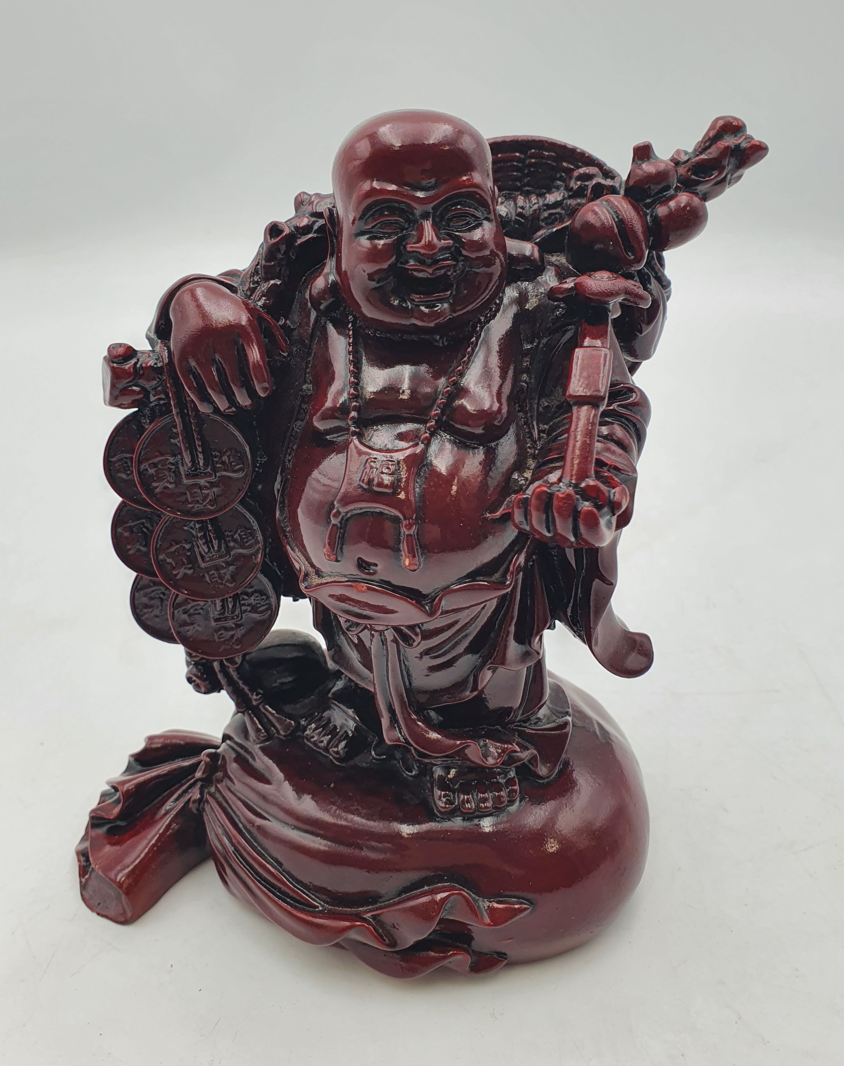 133 · A CHINESE RESIN FIGURE OF LAUGHING BUDDHA