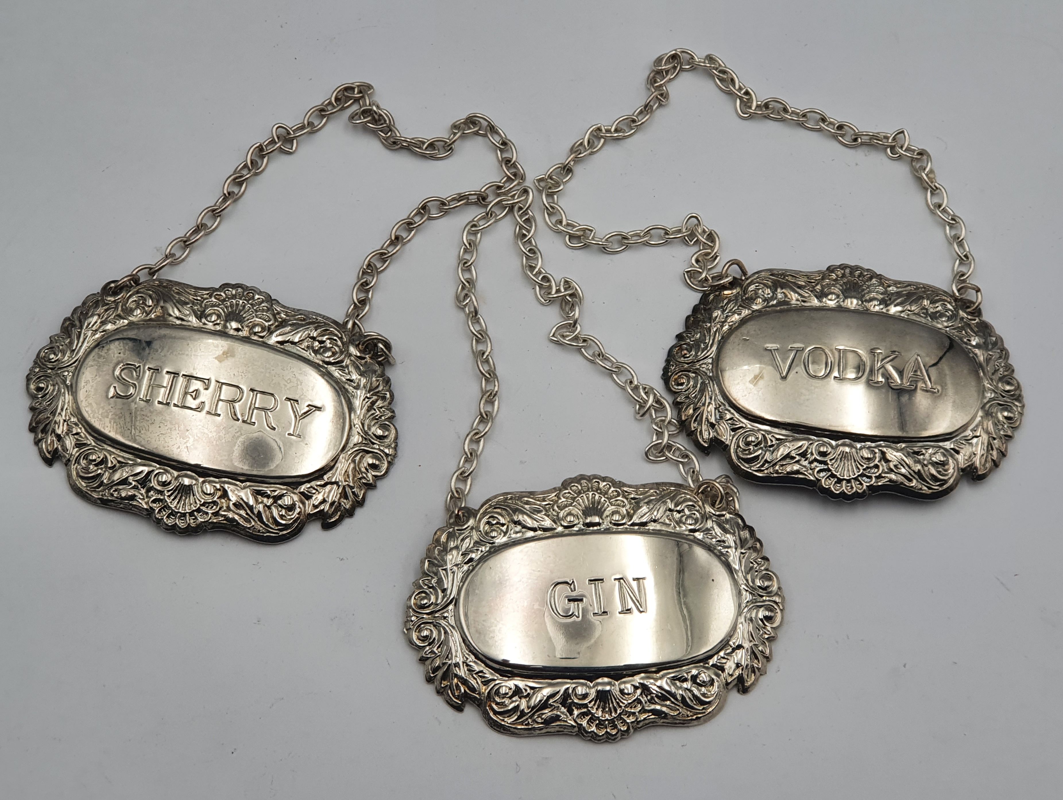 313 · A SET OF SILVERPLATED DECANTER LABELS