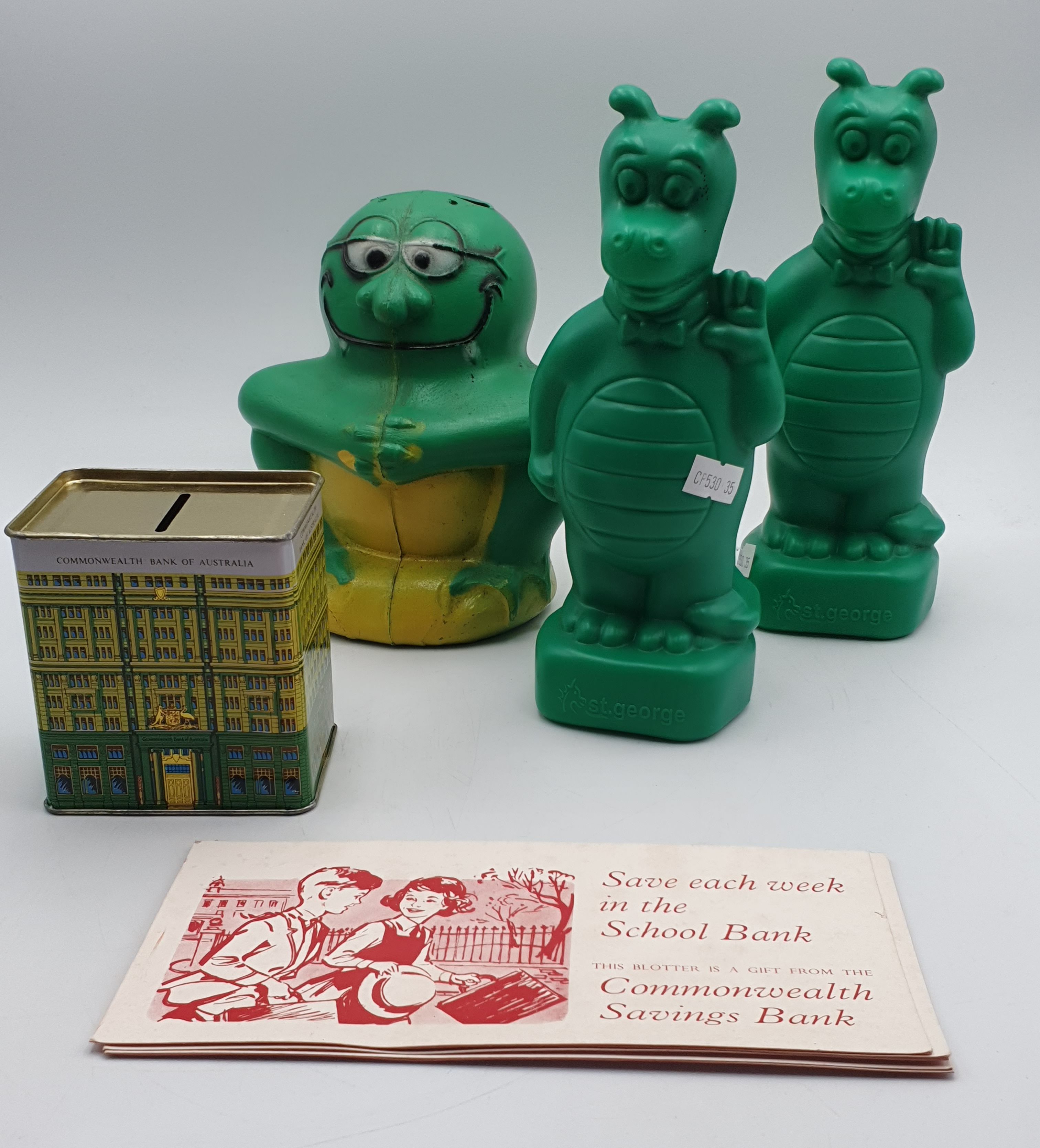 89 · A GROUP OF 20th CENTURY MONEY BOXES AND COMMONWEATH BANK BLOTTER PAPERS