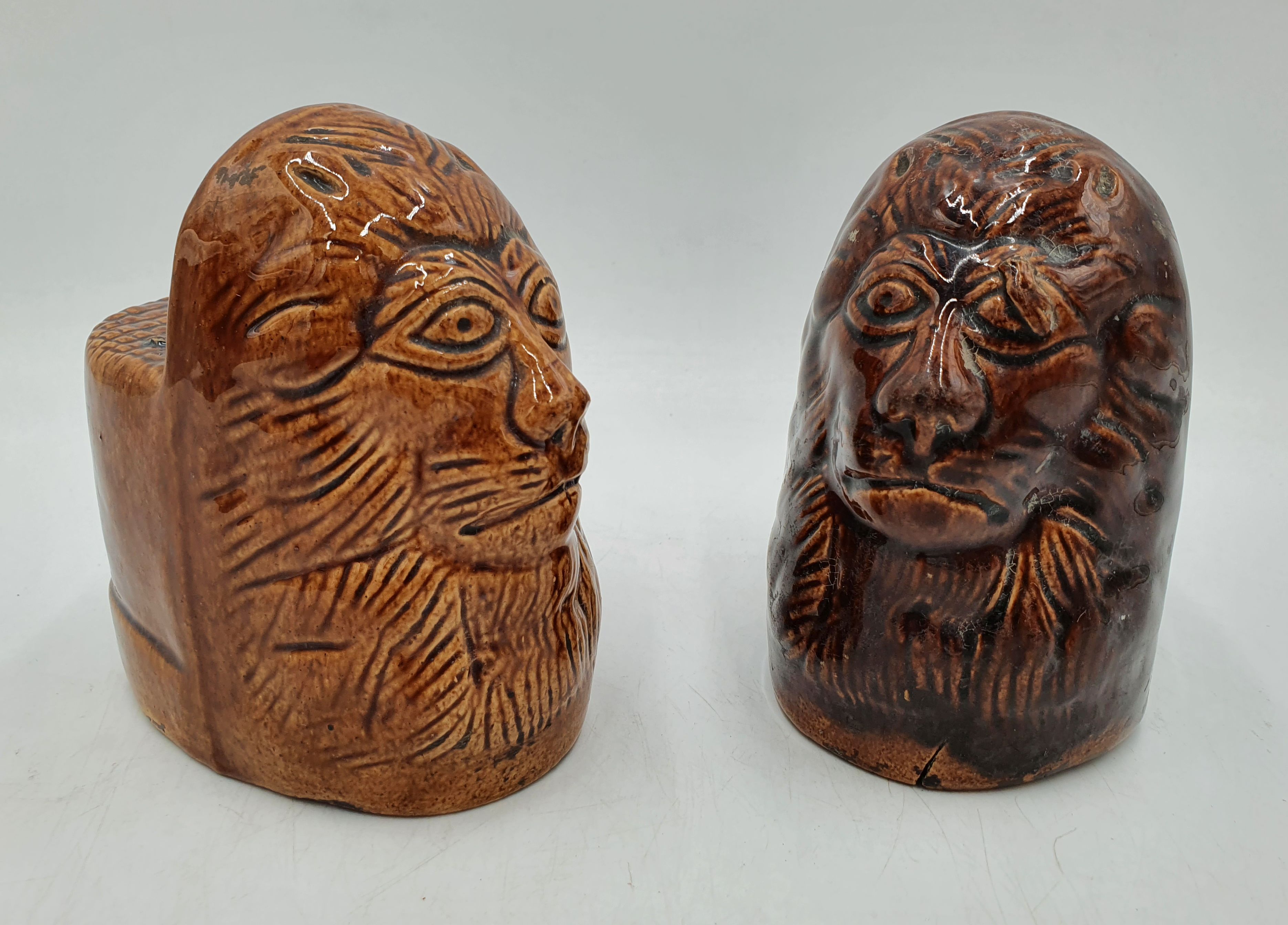 530 · A PAIR OF 19TH CENTURY BROWN MAJOLICA LION HEAD WINDOW STOPS