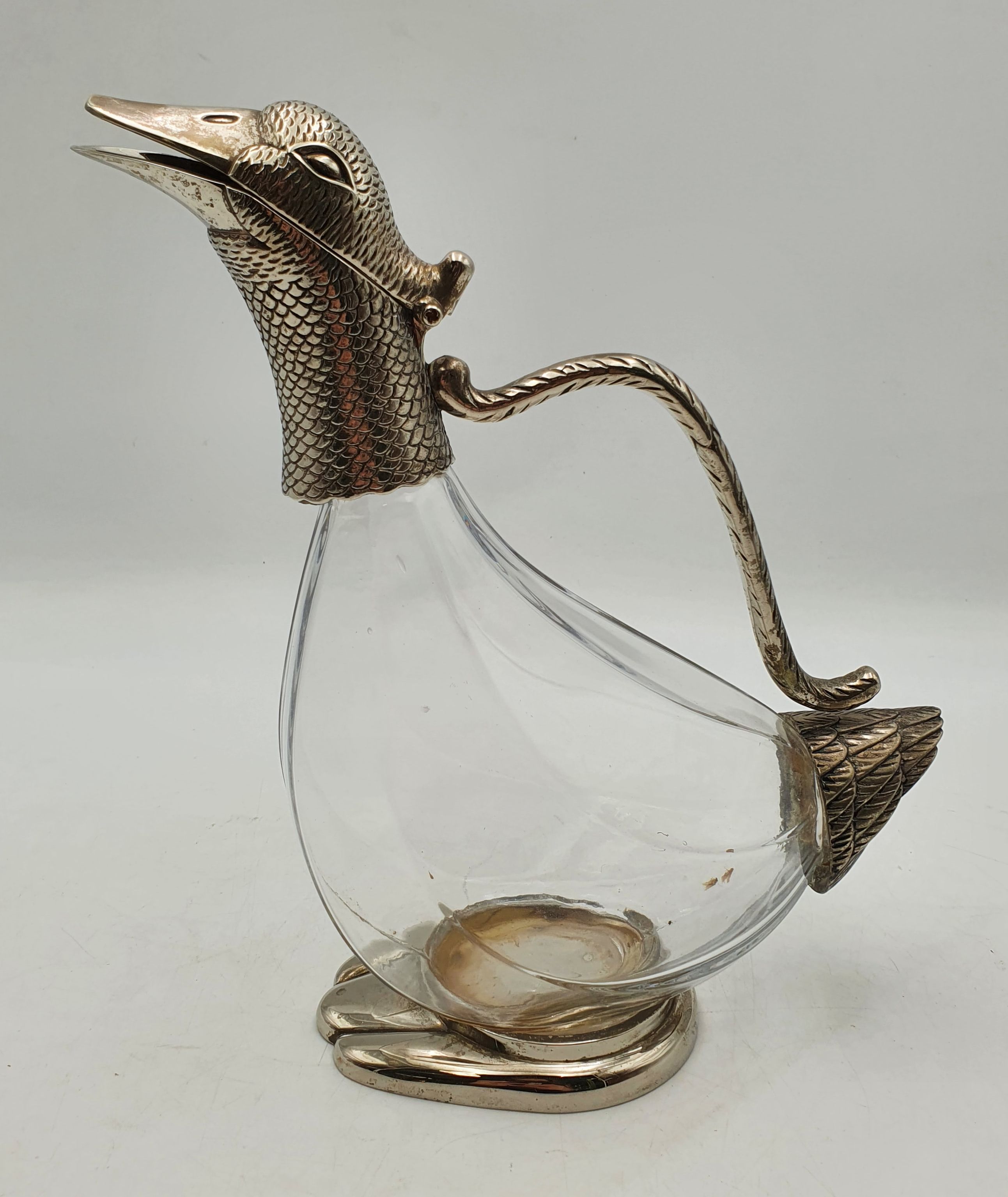 A SILVER PLATED DUCK FORM CLARET JUG