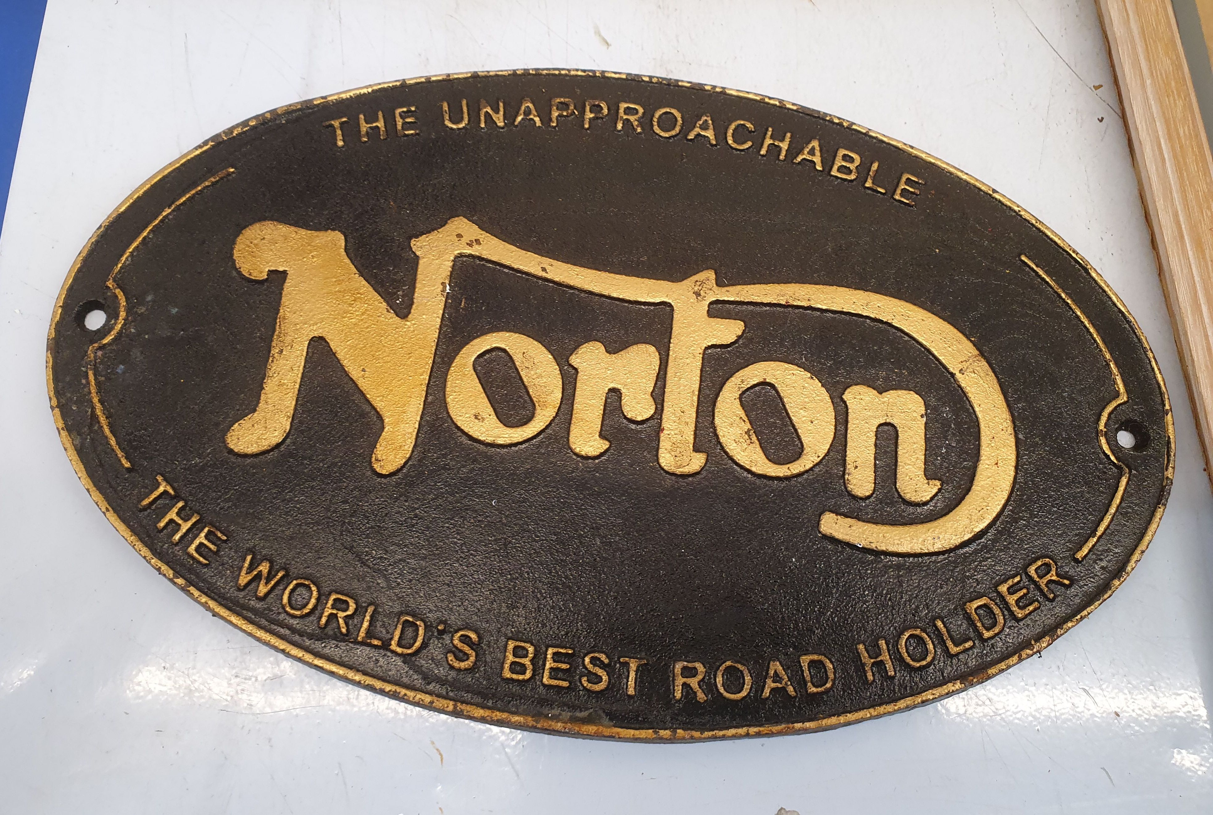A REPRODUCTION CAST IRON 'NORTON' SIGN