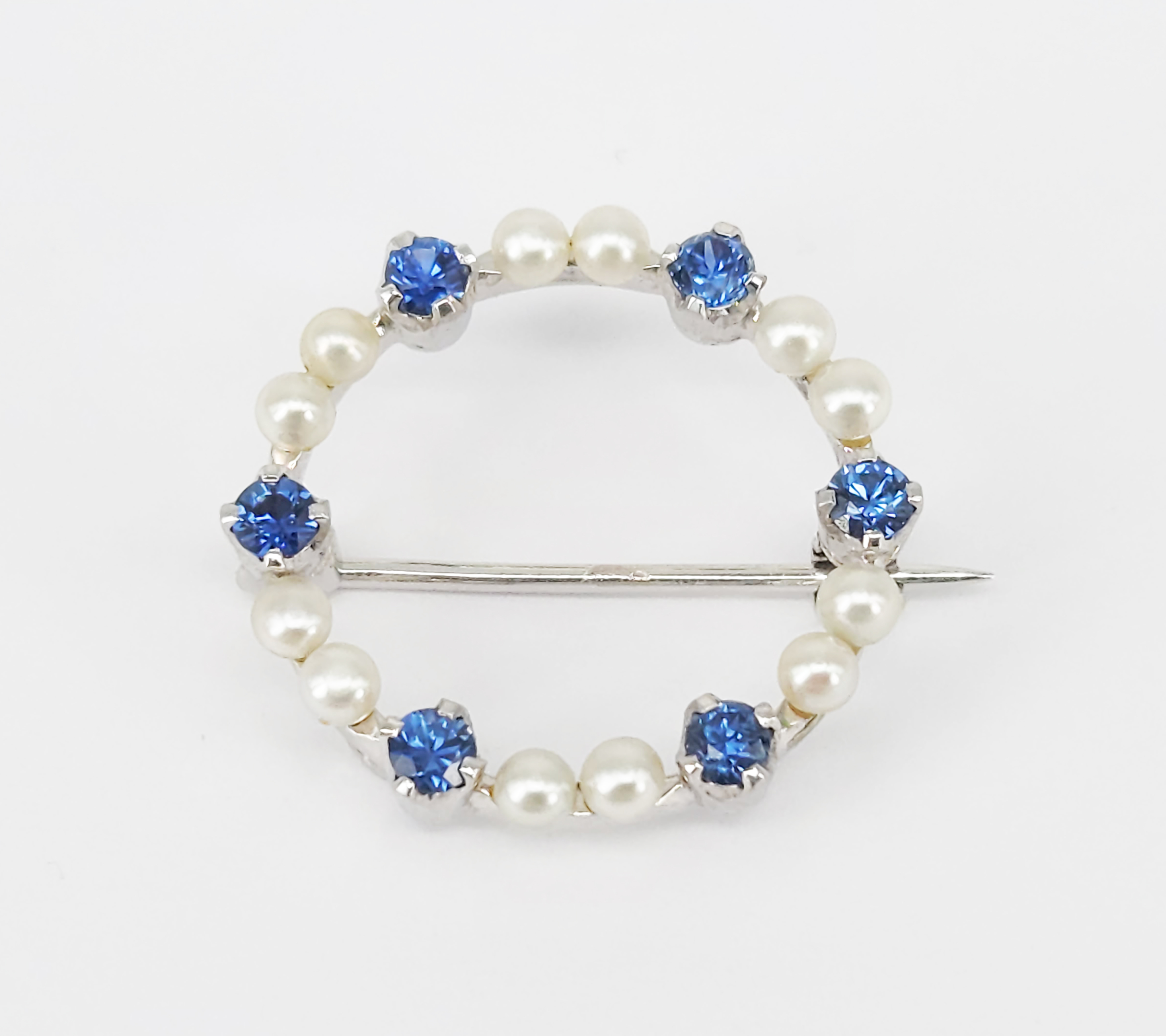 A Blue Sapphire And Seed Pearl Brooch