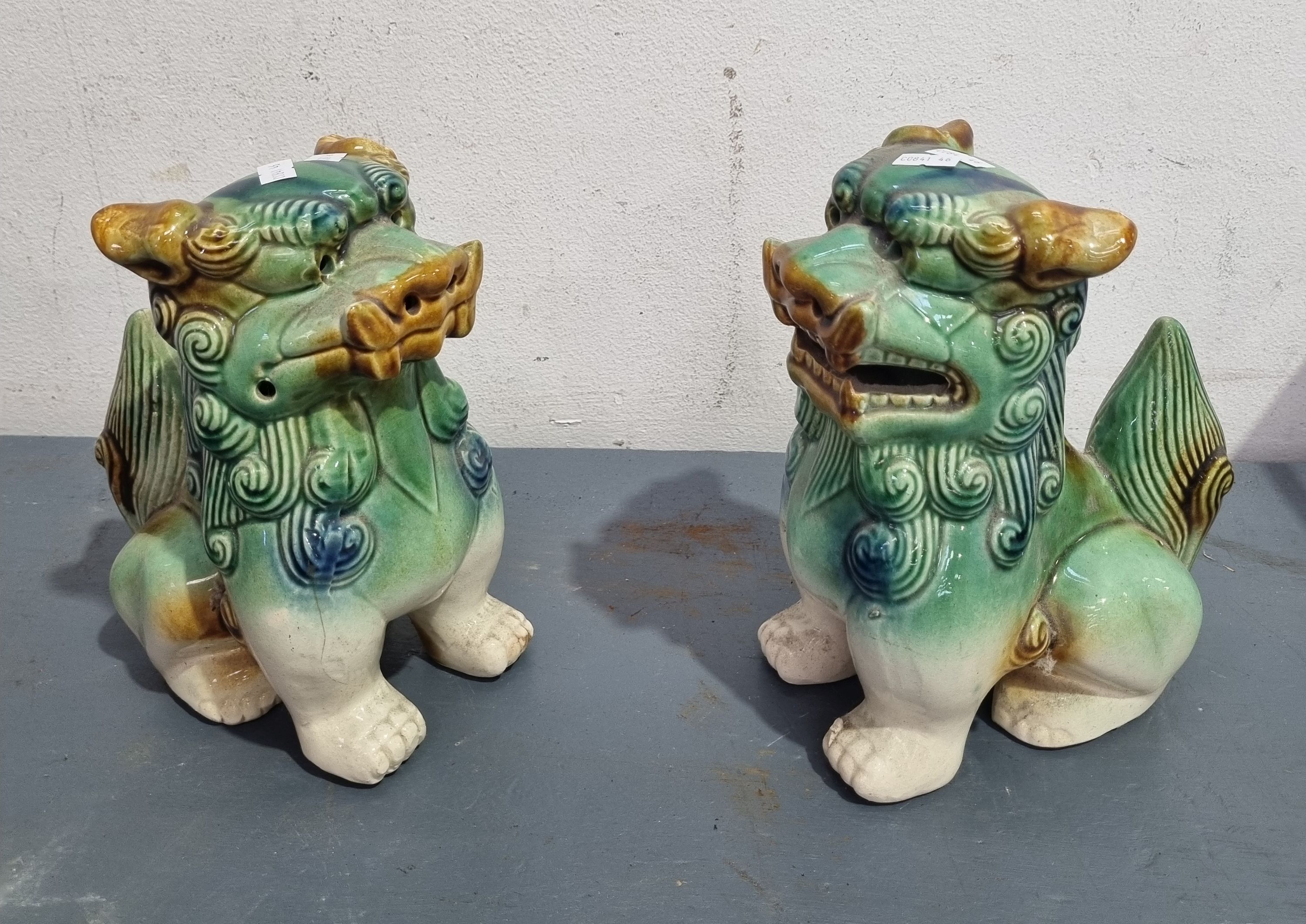 A PAIR OF CERAMIC FOO DOGS