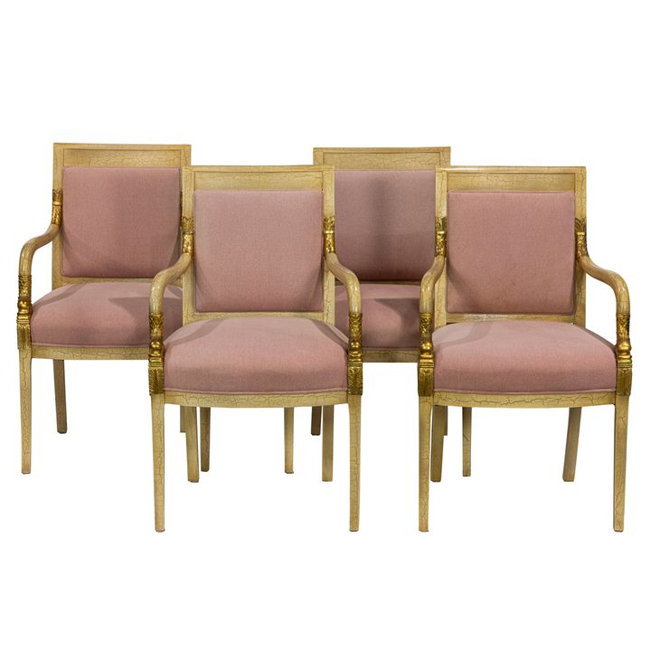 A set of four Neoclassical style parcel gilt cream painted armchairs